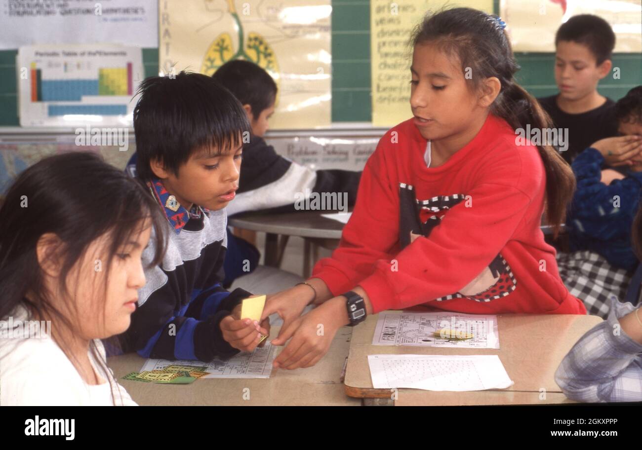 ©1995 Education: Bilingual education in 4th grade fourth grade math class learning fractions with manipulative cards. Stock Photo