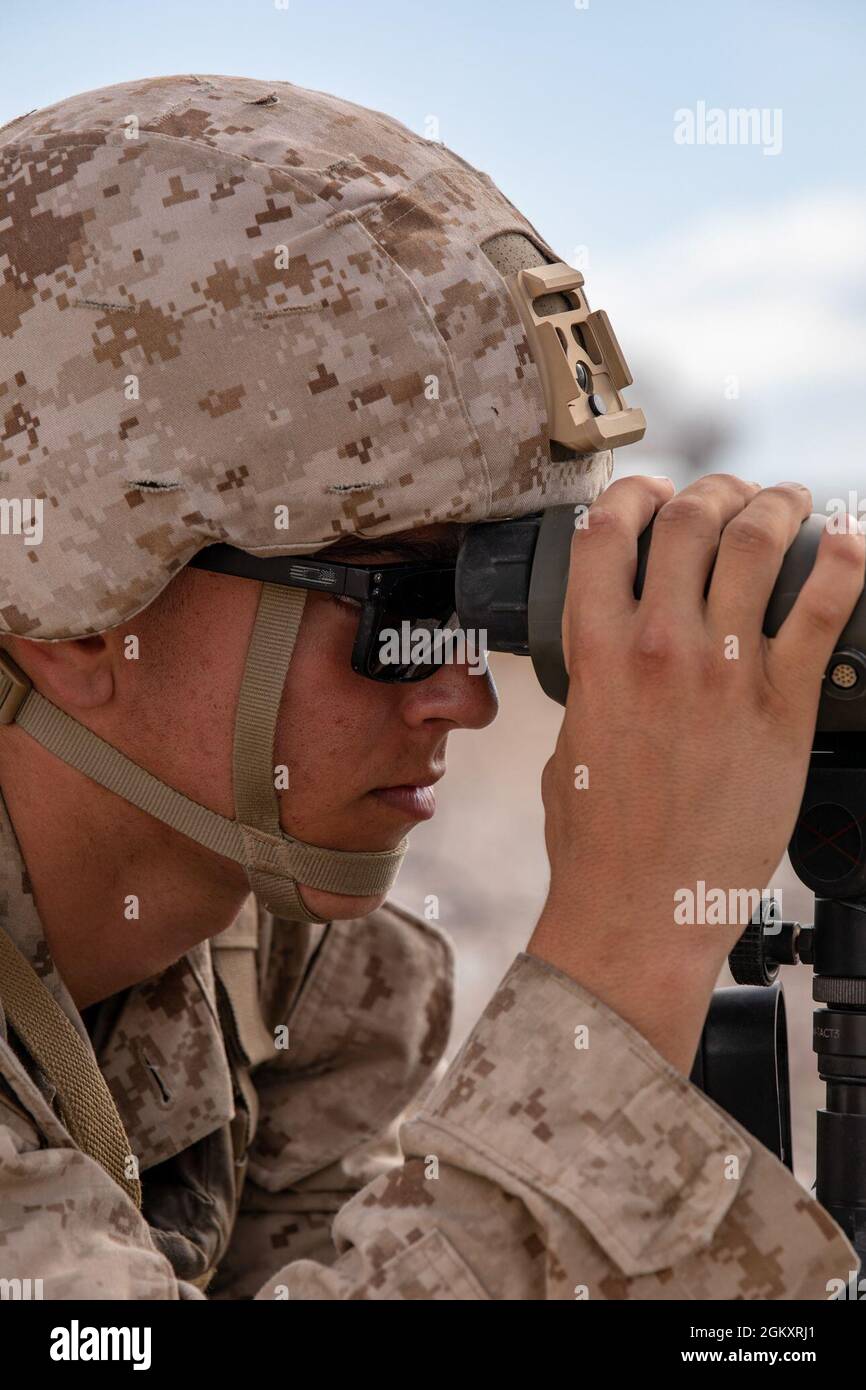 Lance Cpl. Reece Ackerman, a forward air observer with 3rd Battalion, 25th Marines scans for targets during Fire Support Coordination Exercise (FSCEX) 1, a sub-event of Integrated Training Exercise (ITX) 4-21 at Marine Corps Air Ground Combat Center, Twentynine Palms, California on July 22, 2021. FSCEX allows Reserve Marines to coordinate various fires assets from across Marine Air Ground Task Force 25 to eliminate enemy positions in a simulated combat environment. Stock Photo