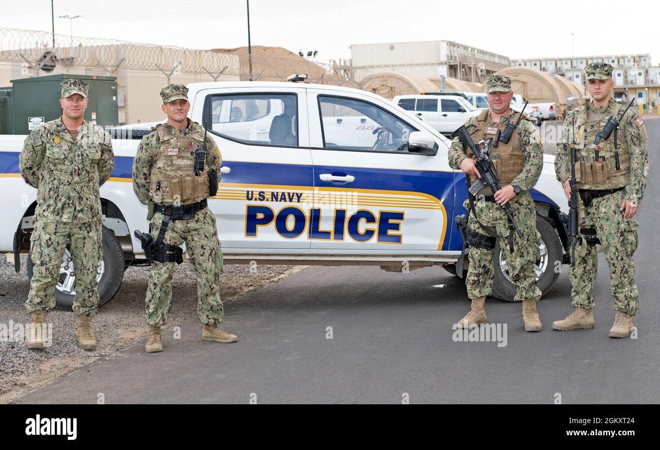 CAMP LEMONNIER, Djibouti (July 21, 2021) (left to right) Chief Master-at-Arms Ben Hersee (New York State Police), Master-at-Arms 1st Class John Seddo (NYPD Strategic Response Group 3), Master-at-Arms 1st Class Thomas Underwood (NYPD Police Serving Area 2), and Master-at-Arms 1st Class Jake Feldman (NYPD 25th Precinct), all four part of the New York Police Department and New York State Police, stand in front of a patrol vehicle at Camp Lemonnier, July 21, 2021. Camp Lemonnier is an operational installation that enables U.S., allied and partner nation forces to be where and when they are needed Stock Photo