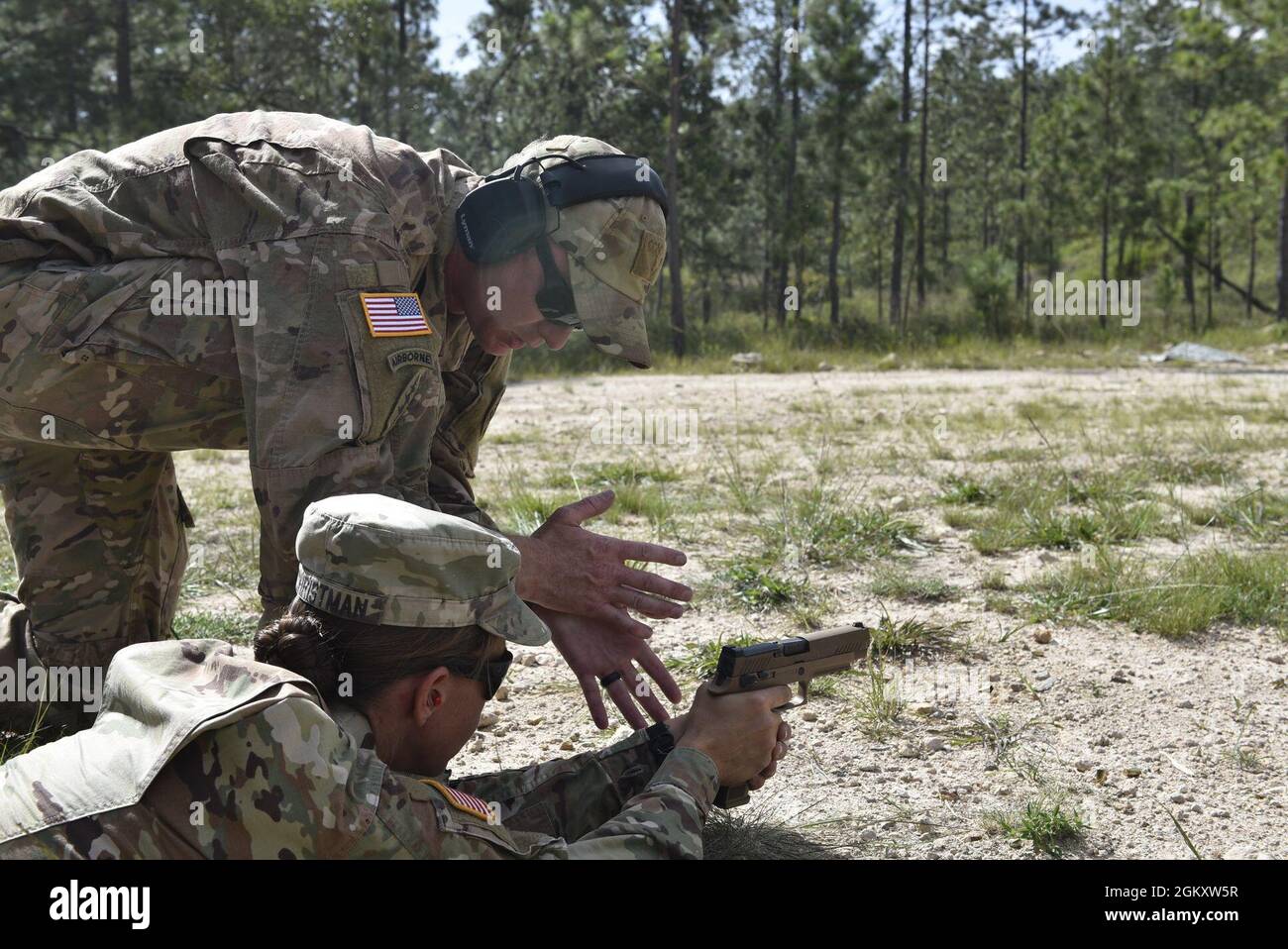 U.S. Army Staff Sgt. Michael Lively, marksmanship trainer and firearms instructor, provides training to Capt. Stephanie Christman, physical therapist with Joint Task Force- Bravo, as she shoots an M17 at the Honduran Army’s 1st Artillery Battalion at Zambrano, department of Francisco Morazán, July 21, 2021. The training consisted of two hours of primary marksmanship instruction, followed by a weapon familiarization session focusing on assembly, maintenance and firing techniques. Stock Photo