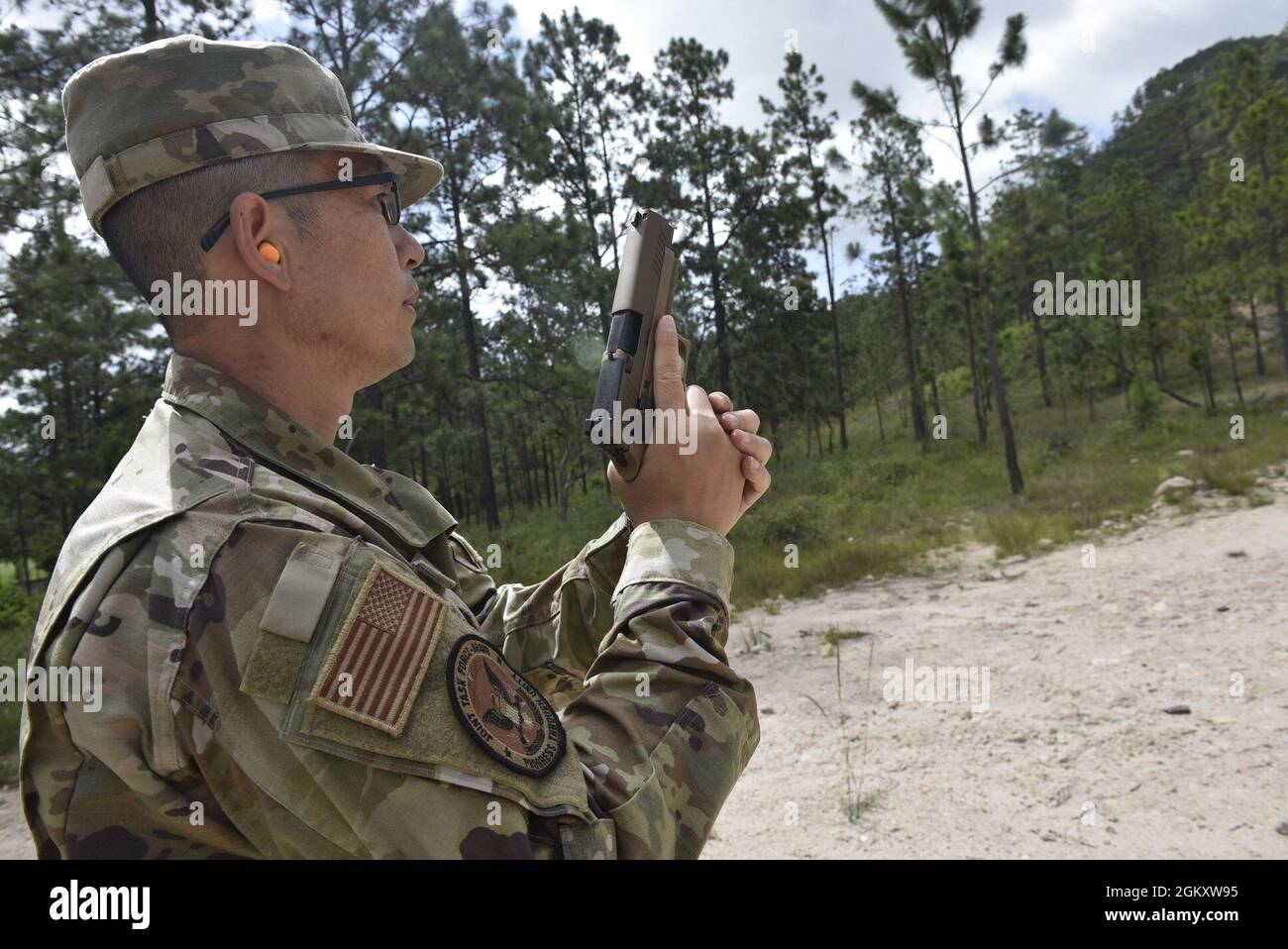 U.S. Air Force Tech. Sgt. Dong Yi, logistics NCO-in-charge with Joint Task-Force Bravo, attends primary marksmanship instruction at the Honduran Army’s 1st Artillery Battalion at Zambrano, department of Francisco Morazán, July 21, 2021. One of U.S. Southern Command’s key objectives is building readiness and joint training opportunities such as these increase interoperability and ensure servicemembers maintain their capabilities to operate within the joint operations area. Stock Photo