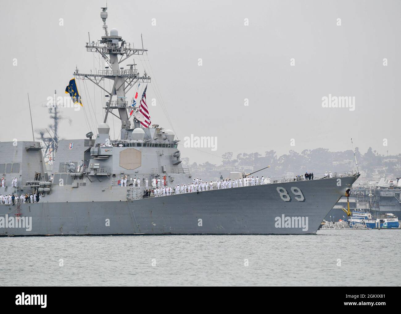 SAN DIEGO (July 22, 2021) - Arleigh Burke-class guided-missile destroyer USS Mustin (DDG 89) returned to San Diego, after 15 years serving in the Forward Deployed Naval Forces (FDNF) in Japan, July 22. Commander, Naval Surface Force, U.S. Pacific Fleet (CNSP) delivers and sustains the full spectrum of balanced, affordable, and resilient naval power through manpower, training, and equipment. As Commander, Naval Surface Forces (CNSF), CNSF leads Surface Warfare policy with a fleet-focused perspective and develops the professional expertise of surface warfare officers. Stock Photo