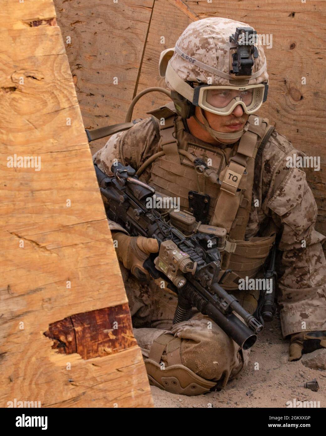 A U.S. Marine with India Company, 3rd Battalion, 25th Marines, 4th Marine Division, prepares to attack an enemy position on Range 410A during Integrated Training Exercise (ITX) 4-21 at Marine Corps Air Ground Combat Center, Twentynine Palms, California on July 22. Range 410A provides Reserve Marines the opportunity to execute a fire and maneuver attack supported by mortarmen, machine gunners and combat engineers. Stock Photo