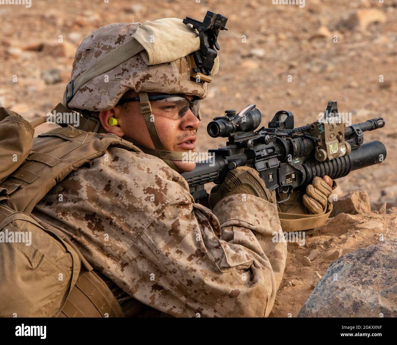 A U.S. Marine with India Company, 3rd Battalion, 25th Marines, 4th Marine Division, advances on a firing position on Range 410A during Integrated Training Exercise (ITX) 4-21 at Marine Corps Air Ground Combat Center, Twentynine Palms, California on July 22. Range 410A provides Reserve Marines the opportunity to execute a fire and maneuver attack supported by mortarmen, machine gunners and combat engineers. Stock Photo