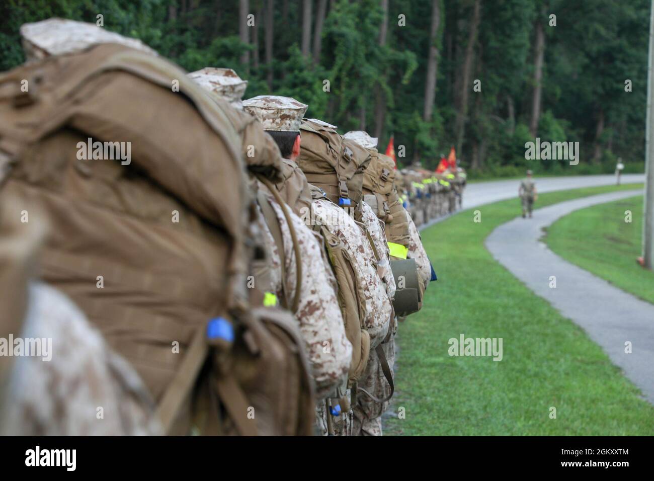 U.S. Navy students and permanent personnel with Field Medical Training Battalion-East (FMTB-E), Training Command, hike two-miles on Camp Johnson, N.C., July 22, 2021. Students participate in four different hikes during a normal training evolution to better prepare themselves for the physical rigors of being corpsmen. Stock Photo