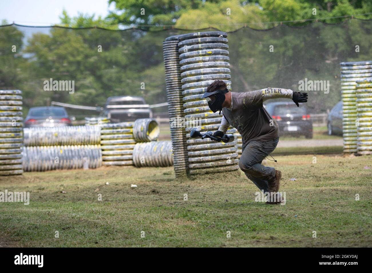 U.S. Navy Machinist’s Mate 2nd Class Ethan Meads, from Jacksonville, Alabama, assigned to the aircraft carrier USS John C. Stennis (CVN 74), sprints across a paintball field during a Morale, Welfare, and Recreation event, in Hampton, Virginia, July 22, 2021. John C. Stennis is in Newport News Shipyard working alongside NNS, NAVSEA and contractors conducting Refueling and Complex Overhaul as part of the mission to deliver the warship back in the fight, on time and on budget, to resume its duty of defending the United States. Stock Photo