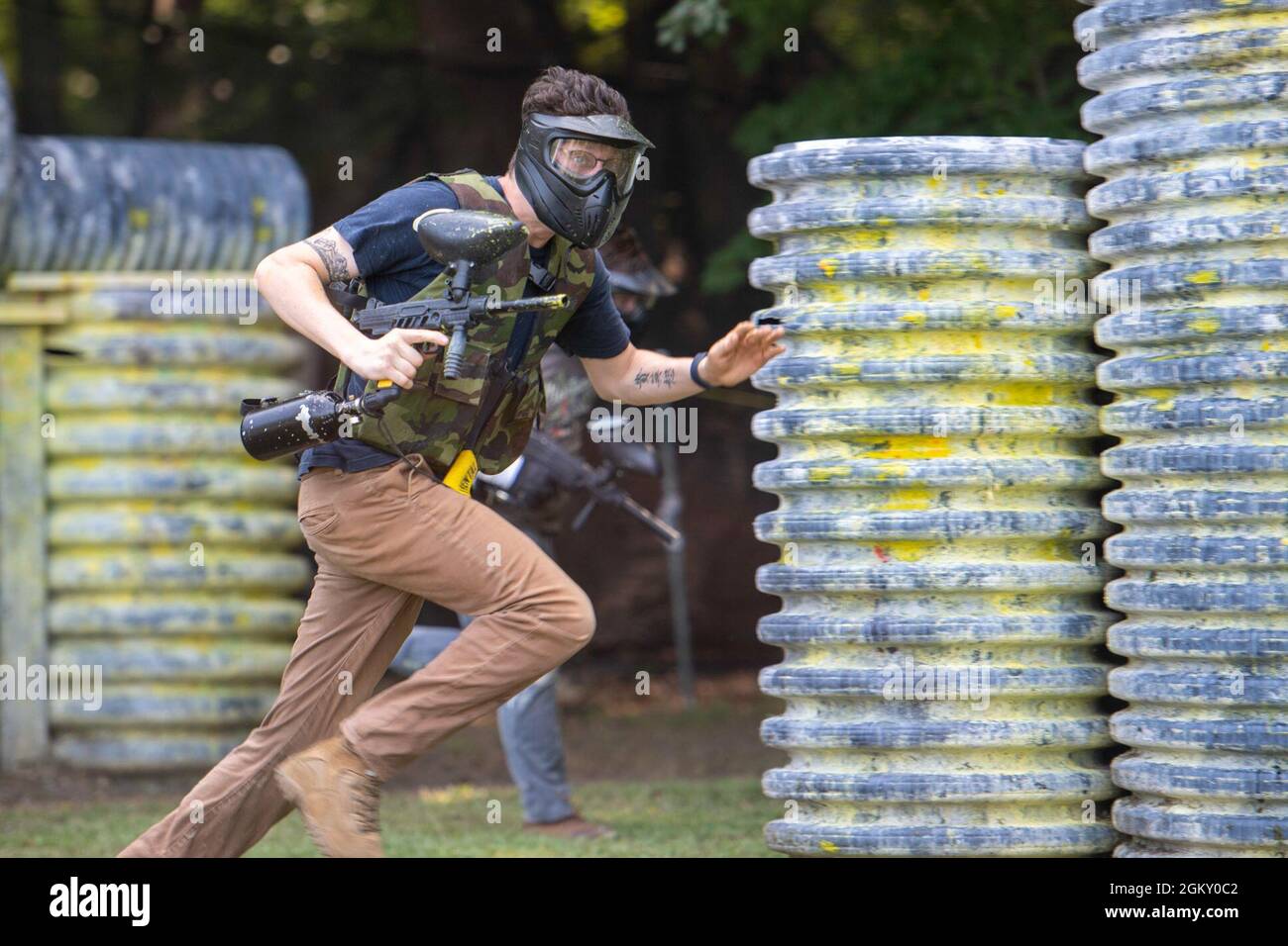 U.S. Navy Logistics Specialist 3rd Class Bailey Stephenson, from Longmont, Colorado, assigned to the aircraft carrier USS John C. Stennis (CVN 74), sprints to cover on a paintball field during a Morale, Welfare, and Recreation event, in Hampton, Virginia, July 22, 2021. John C. Stennis is in Newport News Shipyard working alongside NNS, NAVSEA and contractors conducting Refueling and Complex Overhaul as part of the mission to deliver the warship back in the fight, on time and on budget, to resume its duty of defending the United States. Stock Photo