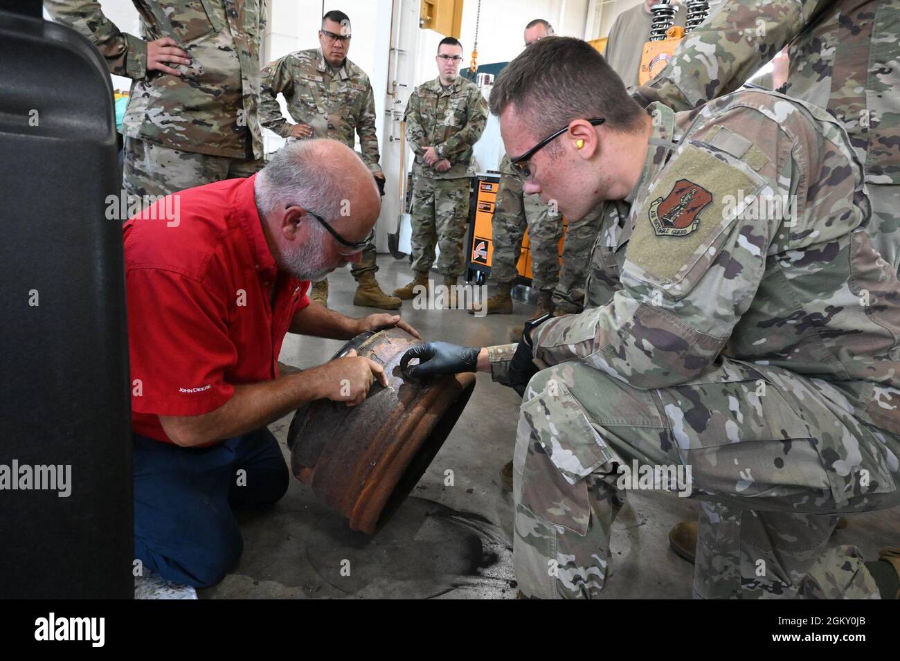 Air brake systems instructor Jim Bainer, red shirt, points out flaws in