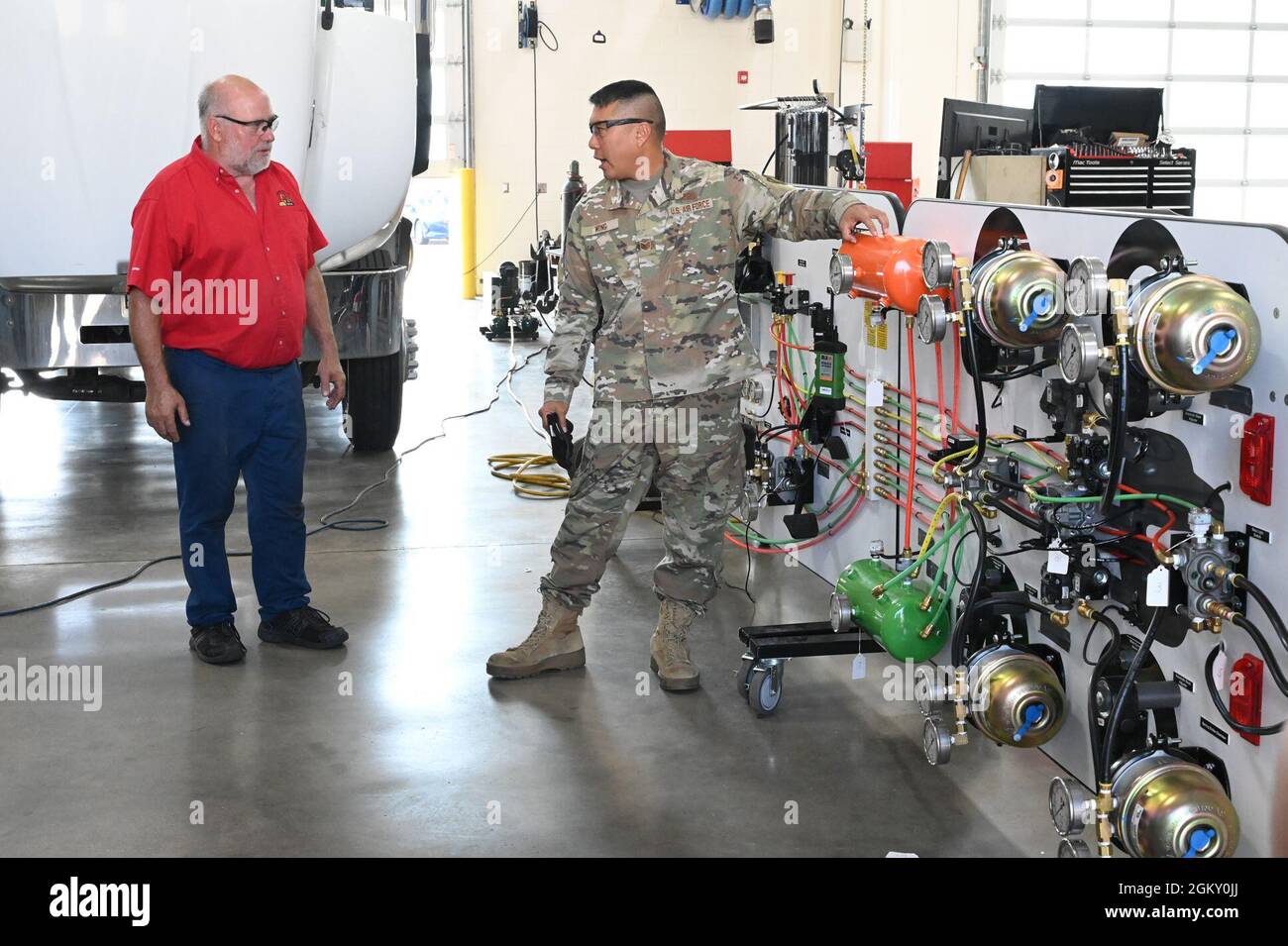 Air brake systems instructor Jim Bainer, red shirt, talks to Tech. Sgt. Garrit Wong, of the 154th Logistics Readiness Squadron, Hawaii Air National Guard, as Bainer provides instruction for Air National Guard students at a high-tech schematic air brake simulator at Minnesota State community College (M State), Moorhead, Minn., July 22, 2021. Thirteen students from six different Air National Guard units in five states are attending the 37.5 hour advanced truck air brake system course hosted by the 119th Wing Logistics Readiness Squadron vehicle maintenance function, and taught through a joint pr Stock Photo