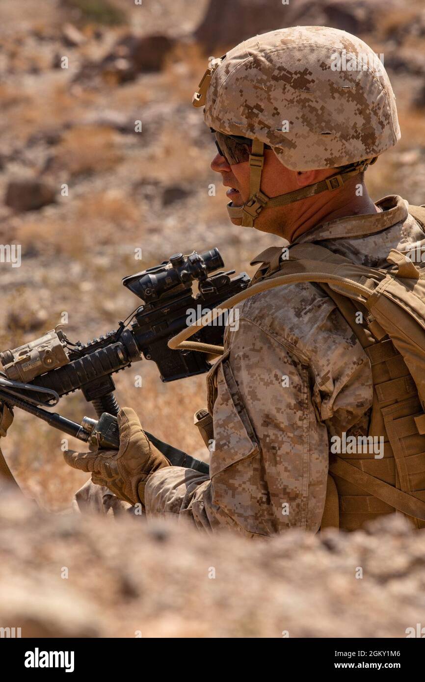 A Marine with Kilo Company, 3rd Battalion, 25th Marines, 4th Marine Division, calls in enemy positions on Range 400 during Integrated Training Exercise (ITX) 4-21 at Marine Corps Air Ground Combat Center, Twentynine Palms, California on July 23, 2021.Range 400 is a company-sized live-fire assault range that requires complex coordination of fires, producing combat-ready Reserve Marines prepared to augment and reinforce the Active Component. Stock Photo