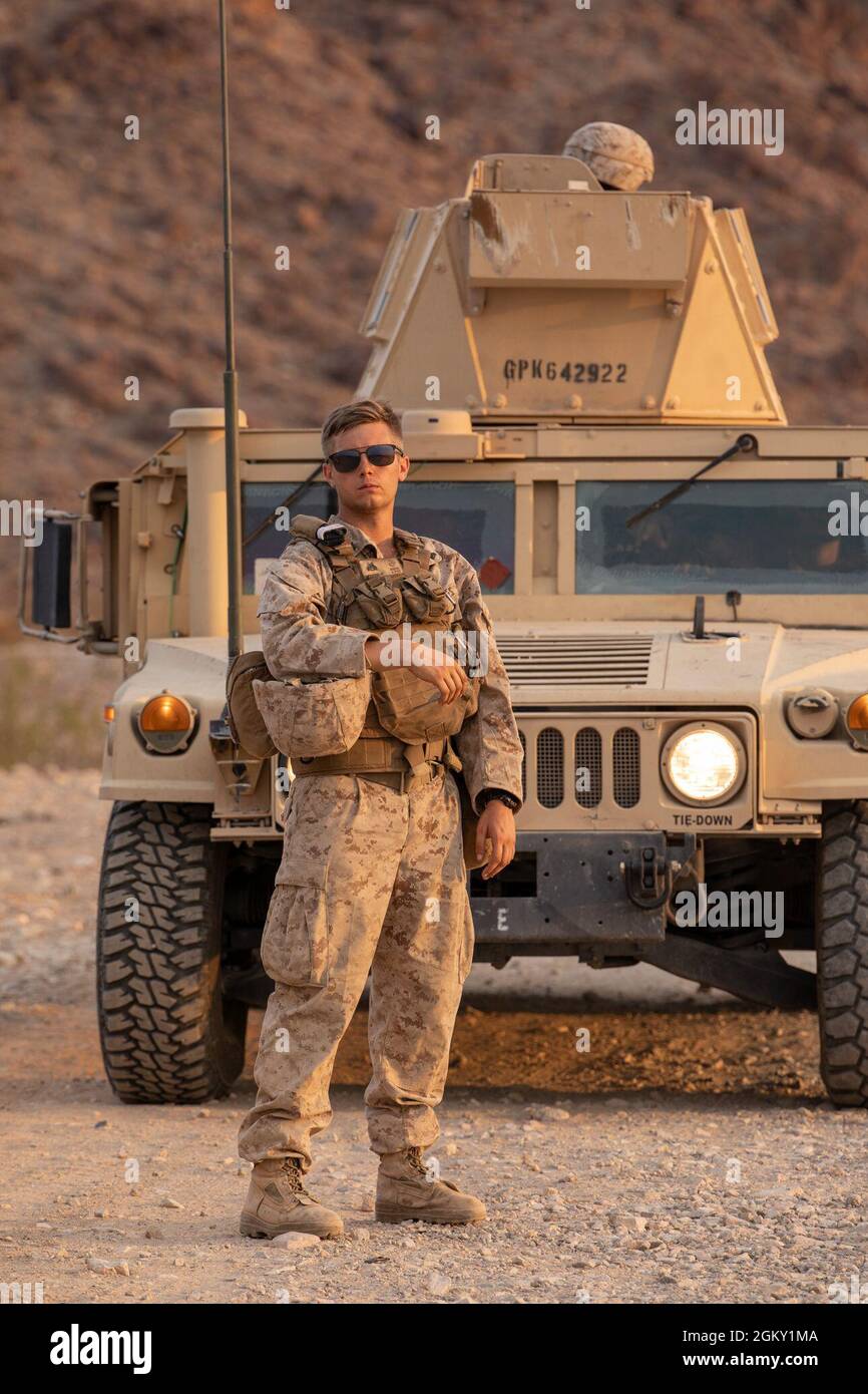 A Marine with 3rd Battalion, 25th Marines, 4th Marine Division, ground guides a Humvee on Range 400 during Integrated Training Exercise (ITX) 4-21 at Marine Corps Air Ground Combat Center, Twentynine Palms, California on July 22. ITX is the culmination of Marine Forces Reserve units’ training cycle as they participate in a live-fire, combined arms exercise as a part of an integrated Marine Air Ground Task Force. Stock Photo