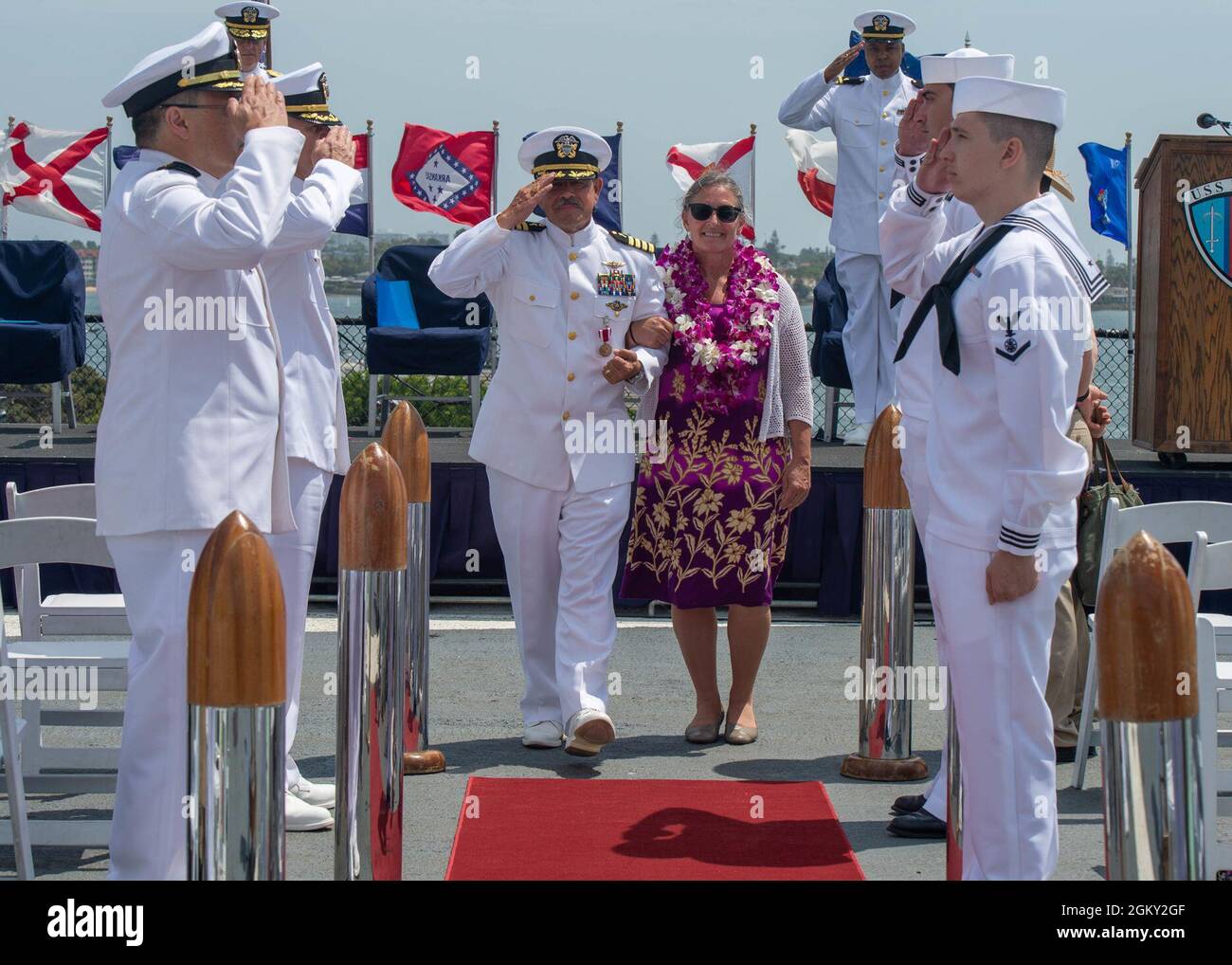 210723-N-XZ205-1332  SAN DIEGO (July 23, 2021) Capt. Philip King, Naval Medical Force Pacific's (NMFP) region chaplain, and Cynthial van Dijk, his wife, are piped ashore during a retirement ceremony aboard the USS Midway museum ship July 23. King retired from the Navy after serving for 41 years. Navy Medicine Readiness and Training Command (NMRTC) San Diego's mission is to prepare service members to deploy in support of operational forces, deliver high quality healthcare services and shape the future of military medicine through education, training and research. NMRTC San Diego employs more th Stock Photo