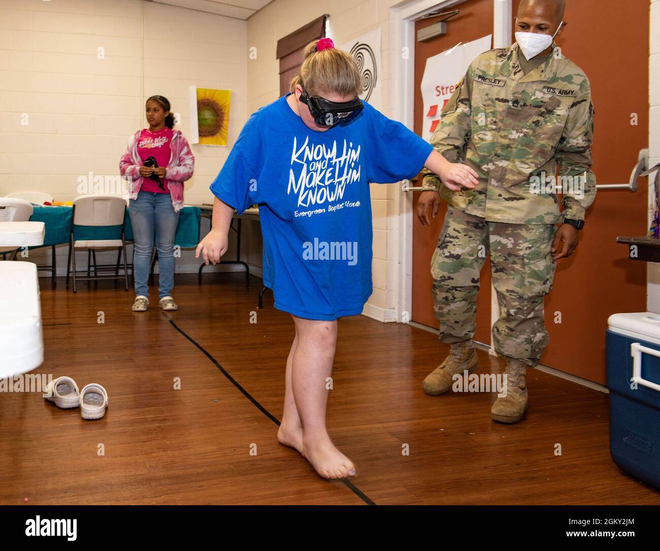 A camper attending a week-long 4H day camp attempts to walk a straight line while wearing fatal vision goggles. The goggles are designed to simulate some effects of alcohol on the wearer. The theme of the week was Street SMARTS in which the students learn skills in the areas of safety, mindfulness, acceptance and resilience. Stock Photo