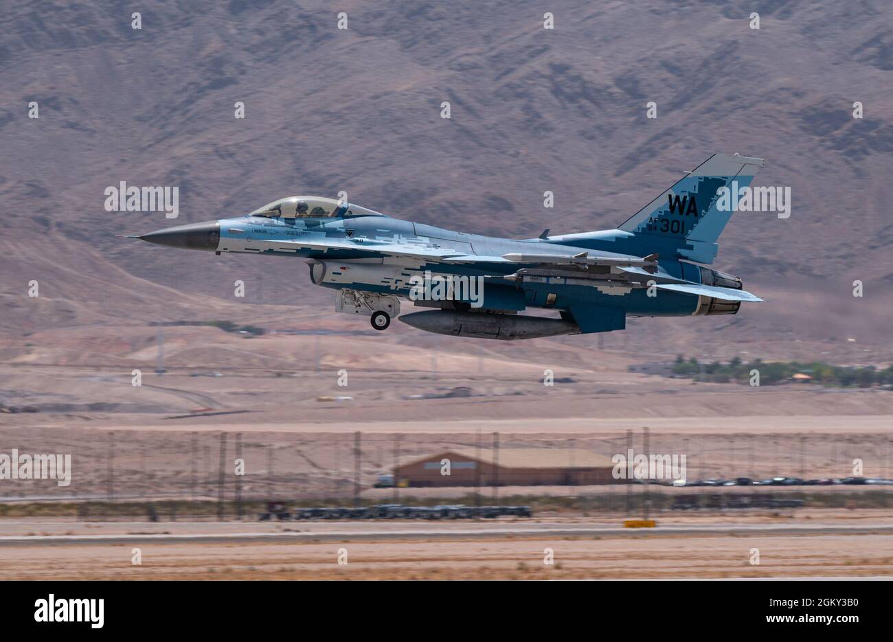 An F-16C Falcon fighter jet assigned to the 64th Aggressor Squadron, takes-off for a Red Flag 21-3 mission, at Nellis Air Force Base, Nevada, July 23, 2021. The Aggressor’s primary mission is to prepare the combat air forces, joint, and allied aircrews with realistic and challenging threat replication, training and feedback. Stock Photo
