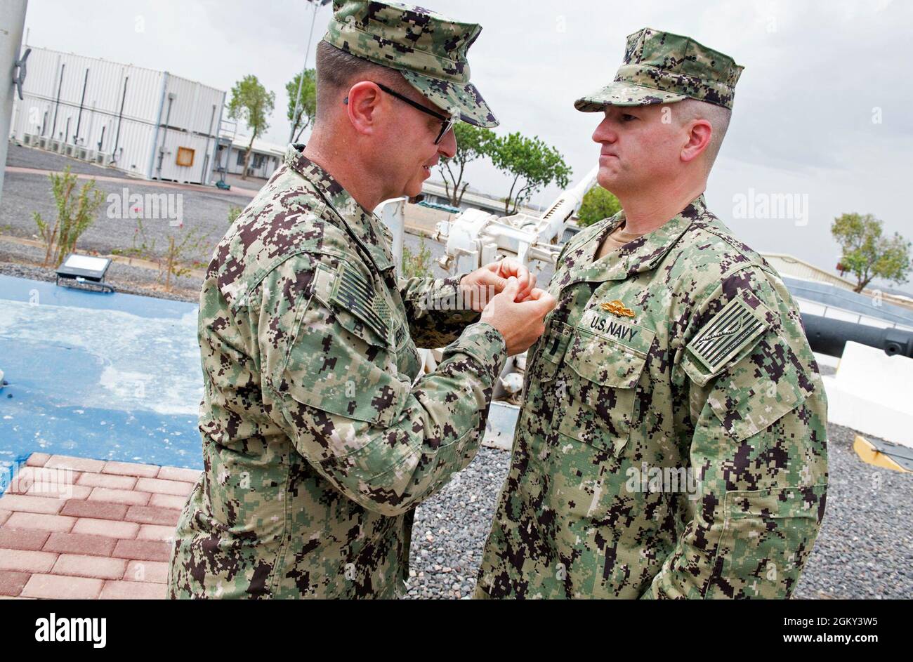 CAMP LEMONNIER, Djibouti (July 24, 2021) U.S. Navy Rear Adm. Michael Curran, Fleet Supply, Logistics, and Ordnance, U.S. Naval Forces Europe/Africa/Sixth Fleet, awards Lt.j.g. Webster McClure, from Stafford, Va., the Navy Expeditionary Supply Corps Officer Warfare pin, July 24, 2021. Camp Lemonnier is an operational installation that enables U.S., allied and partner nation forces to be where and when they are needed to ensure security in Europe, Africa and Southwest Asia. Stock Photo
