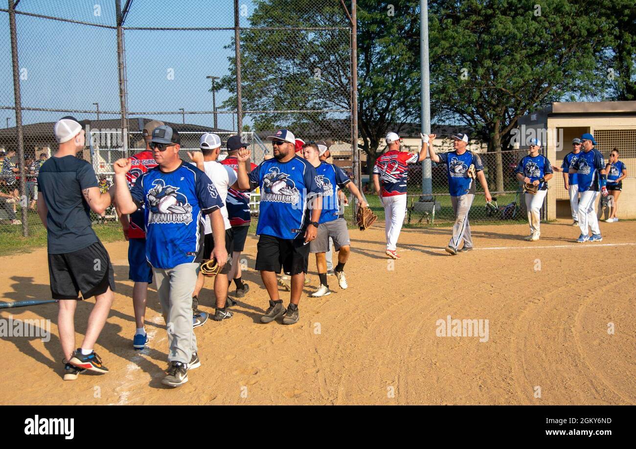 Airmen from the 436th Security Forces Squadron and 436th Maintenance Squadron Isochronal Maintenance Dock congratulate each other after an intramural softball game on Dover Air Force Base, Delaware, July 26, 2021. The 436th SFS won the game 13-4. Stock Photo