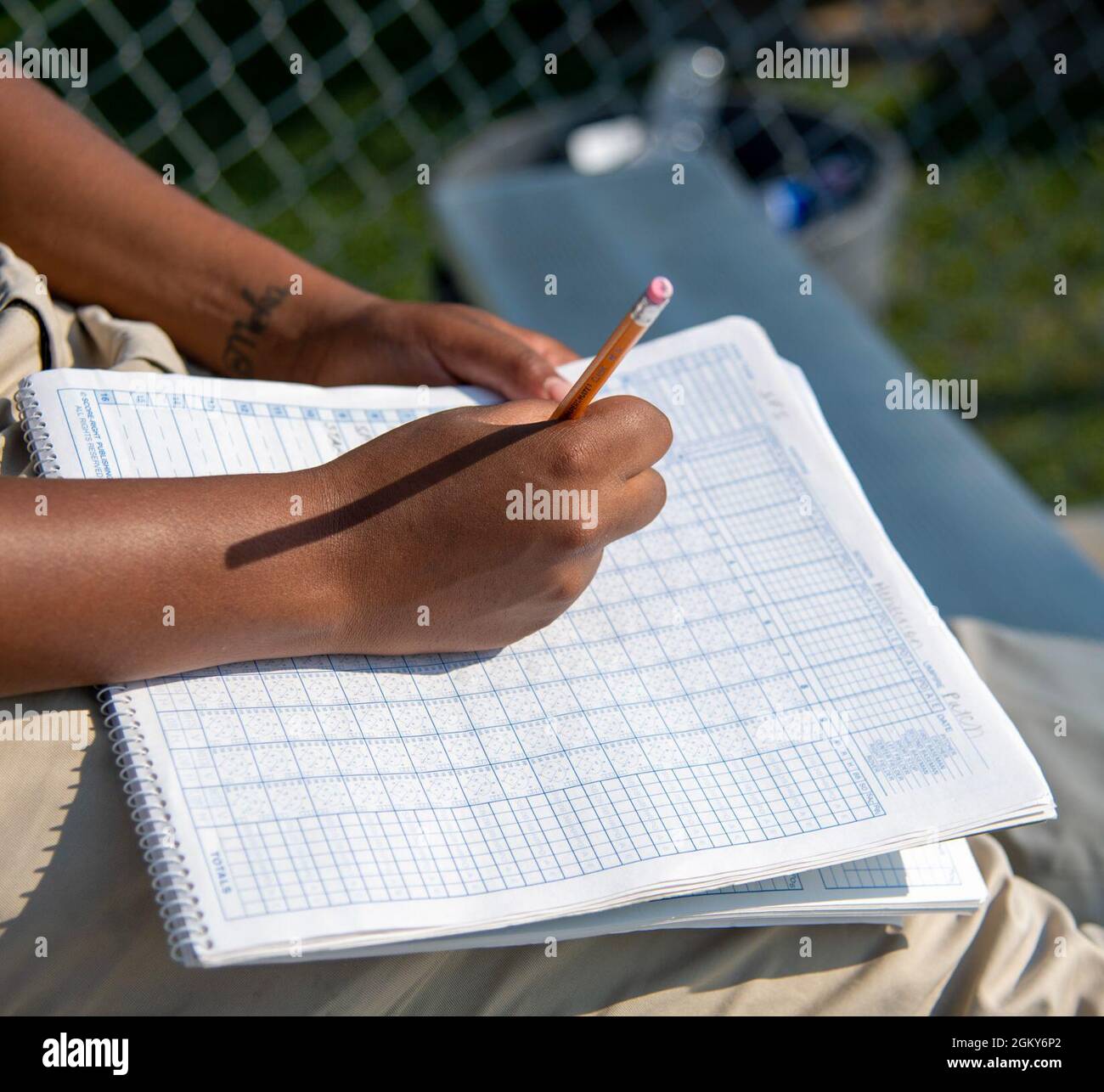 Airman 1st Class Cherish Henderson, 436th Force Support Squadron fitness center specialist, maintains the official scorebook during an intramural softball game between the 436th Security Forces Squadron and the 436th Maintenance Squadron Isochronal Maintenance Dock on Dover Air Force Base, Delaware, July 26, 2021. The 436th SFS won the game 13-4. Stock Photo