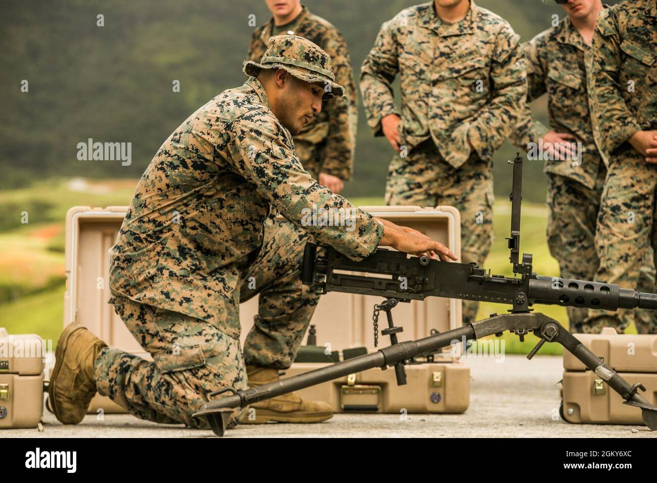 U.S. Marine Corps Cpl. Idan Urrutiagarces, a section leader with Fox Company, 2nd Battalion, 2nd Marines, 3d Marine Division, teaches Marines how to operate an M2 .50-caliber machine gun before conducting a machine gun course of fire on Range 10, Camp Schwab, Okinawa, Japan, July 26, 2021. Marines with 3d Landing Support Battalion, Combat Logistics Regiment 3, 3d Marine Logistics Group, assisted by Marines with 2/2, conducted a range to maintain proficiency while utilizing mounted M2 .50-caliber and M240B medium machine guns. 3d MLG, based out of Okinawa, Japan, is a forward deployed combat un Stock Photo