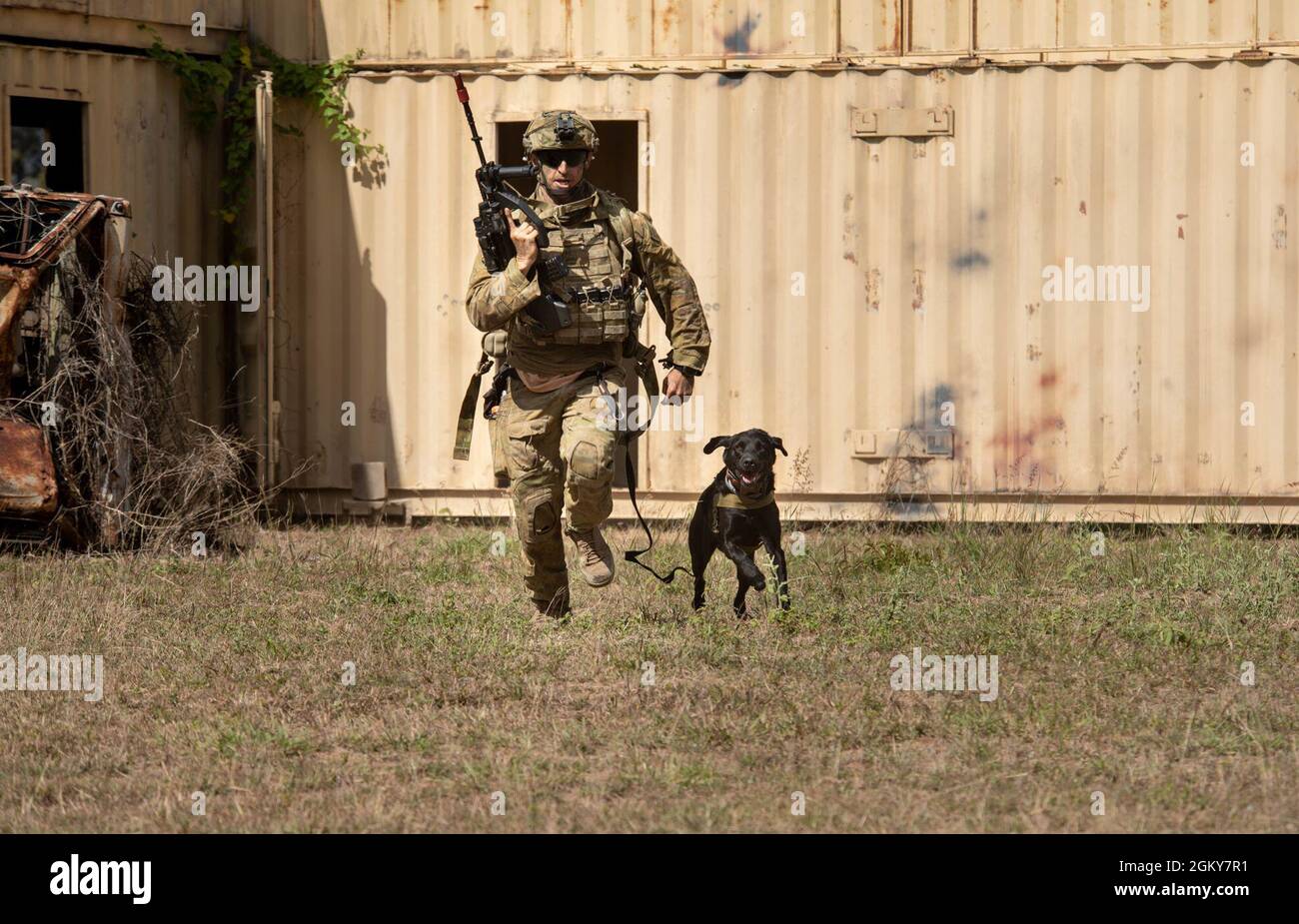 Australian Defence Force Spr. Philips, an explosive ordnance disposal dog handler 3rd Engineer Regiment, pushes toward his objective during a combined urban clearance at Exercise Talisman 21 in