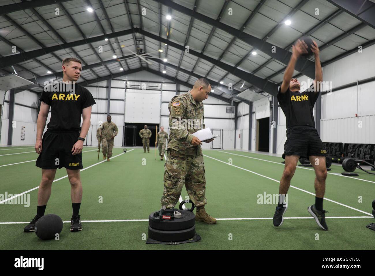 Soldiers complete the standing power throw portion of the Army Combat