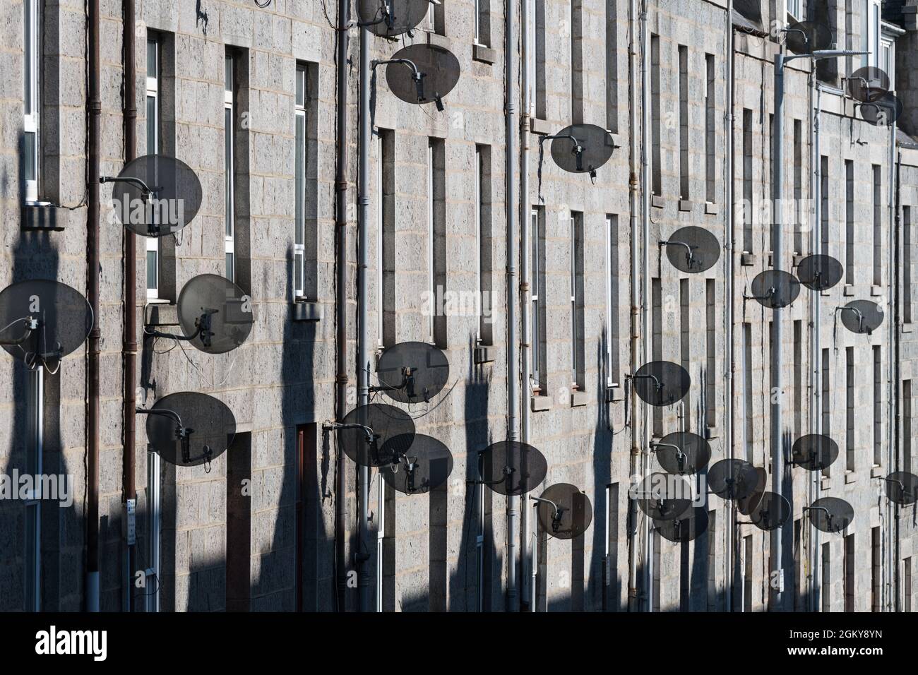 Satellite dishes on front of tenement buildings on Esslemont Avenue, Aberdeen, Scotland, UK Stock Photo