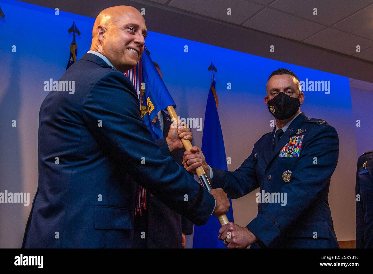 U.S. Air Force Col. William Wallis, right, 65th Air Base Group incoming commander, assumes command of the 65th ABG from U.S. Air Force Brig. Gen. Josh Olson, left, 86th Airlift Wing commander, at Lajes Field, Azores, July 27, 2021. The 65th ABG plays a vital role in combat operations enabling the movement of military members and aircraft supporting joint, coalition and NATO operations as part of U.S. and Allied Air Expeditionary Forces. Stock Photo