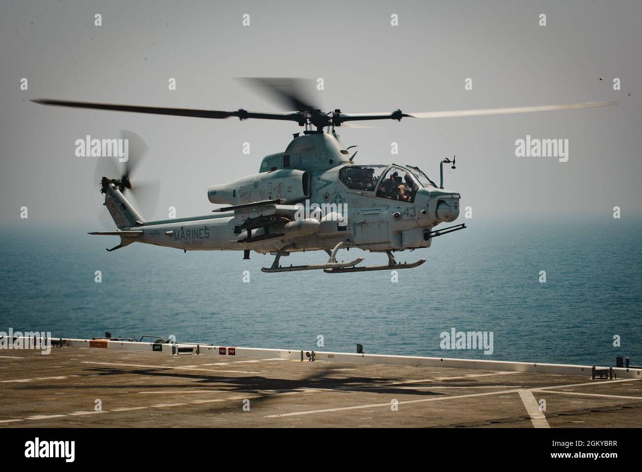 210727-N-KZ419-1071 ARABIAN GULF (July 27, 2021) – An AH-1W Super Cobra attached to Marine Medium Tiltrotor Squadron (VMM) 162 lands aboard expeditionary sea base USS Lewis B. Puller (ESB 3) during flight operations in the Arabian Gulf, July 27. Lewis B. Puller is deployed to the U.S. 5th Fleet area of operations in support of naval operations to ensure maritime stability and security in the Central Region, connecting the Mediterranean and Pacific through the western Indian Ocean and three strategic choke points. Stock Photo