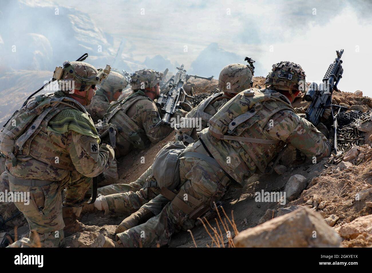 Soldiers with the 45th Infantry Brigade Combat Team fire weapons over a ...