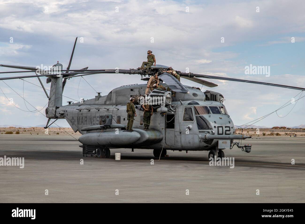 Marines with Marine Heavy Helicopter Squadron (HMH) 772 perform maintenance  on a CH-53E Super Stallion helicopter during Integrated Training Exercise  (ITX) 4-21 at Marine Corps Air Ground Combat Center, Twentynine Palms,  California