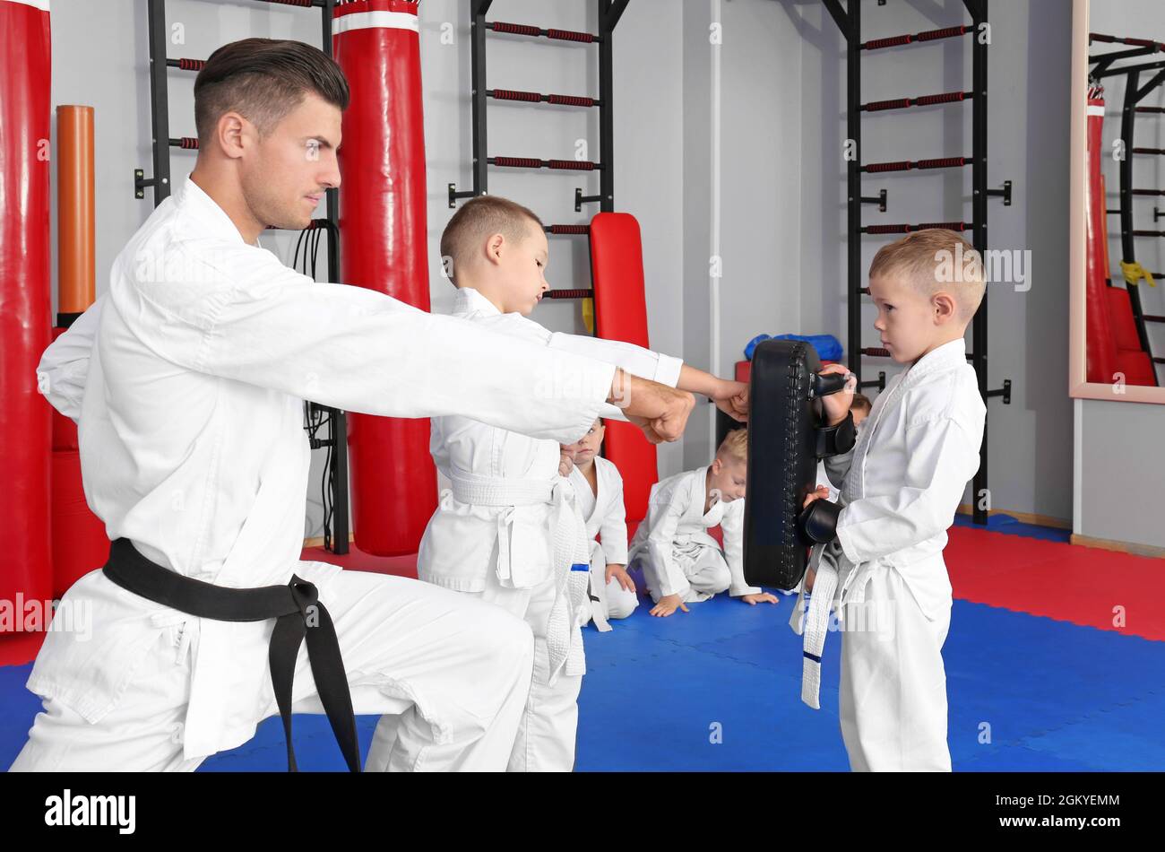 Male karate instructor training little children in dojo Stock Photo Alamy