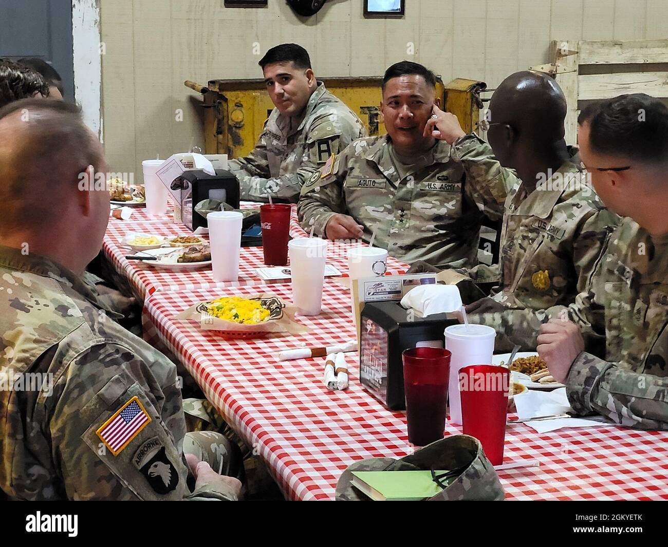 Lt. Gen. Antonio A. Aguto, commanding general of First Army (center-right), meets with OC/Ts from 120th Infantry Brigade and 166th Aviation Brigade over a lunch at Barebones BBQ restaurant in Gatesville, Texas on July 28, 2021. Topics discussed included the commanding general's interest in the daily work of the OC/Ts, Soldier welfare, and shared Army training stories. Stock Photo