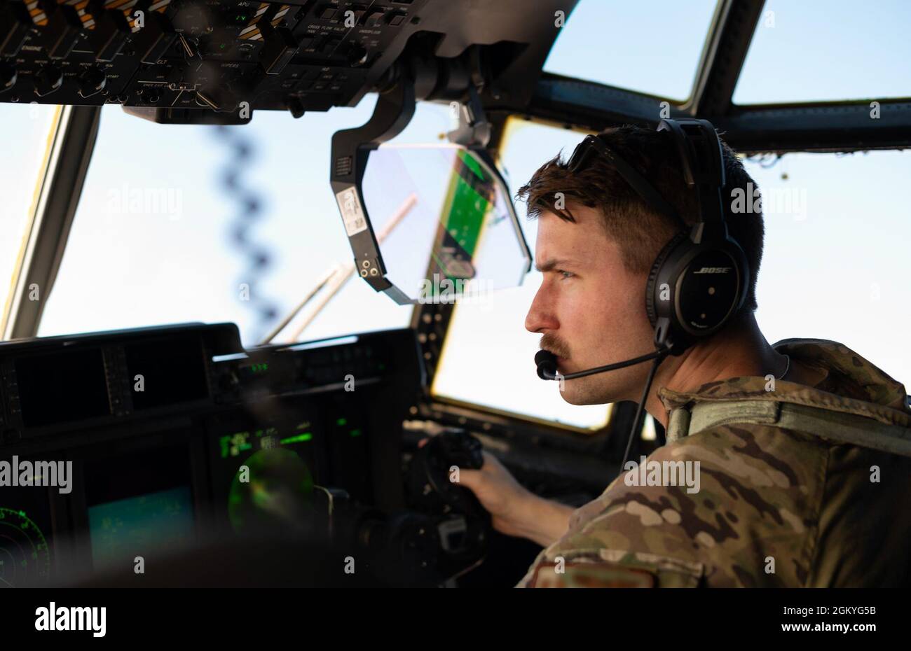 A U.S. Airman from the 26th Expeditionary Rescue Squadron copilots an HC-130J Combat King II during an exercise July 28, 2021, at an undisclosed location somewhere in Southwest Asia. The 26th ERQS stands alert for the U.S. Central Command area of responsibility, providing tanker capability for the associated HH-60G Pave Hawk helicopters and can also provide a forward refueling point in austere locations. Stock Photo