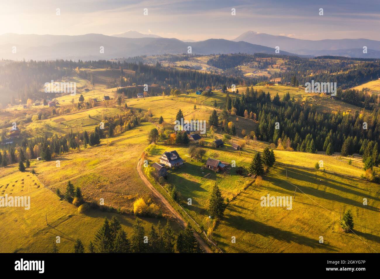 Aerial view of beautiful village in mountains at sunset Stock Photo