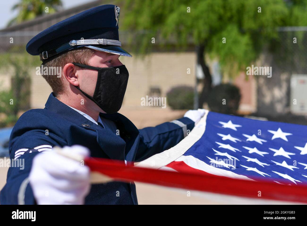 U.S. Air Force Senior Airman Blake Davidson, 56th Fighter Wing ceremonial guardsman, displays the American flag during a flag folding ceremony July 28, 2021, at Luke Air Force Base, Arizona. The Luke AFB Honor Guard is responsible for a large amount of Arizona’s ceremonies, providing coverage to six different counties. The base honor guard’s primary mission is to provide military funeral honors for active-duty members as well as retirees and veterans who served honorably in the U.S. Air Force and Army Air Corps. Stock Photo