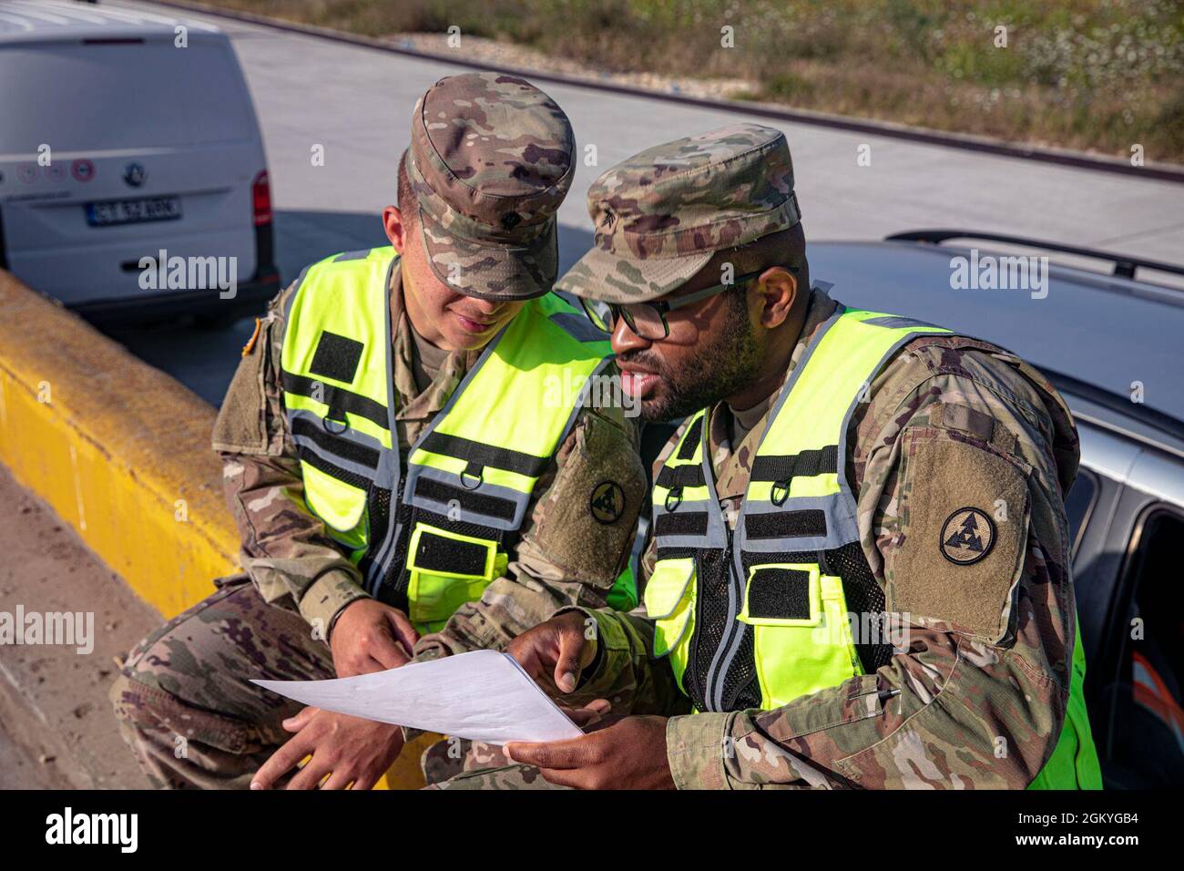 Soldiers assigned to 1st Battalion, 16th Infantry Regiment, 1st Heavy Brigade Combat Team, 1st Infantry Division conducted railhead operations to deliver a fleet of military vehicles to MK Air Base, Romania on July 28, 2021. U.S. Army Sgt. Jamal Slaughter and Spc. Eduardo Rivera, assigned to 261st Movement Control Team, 330th Transportation Battalion, 3rd Sustainment Command (Expeditionary), oversee the safety of the railhead operations. Stock Photo