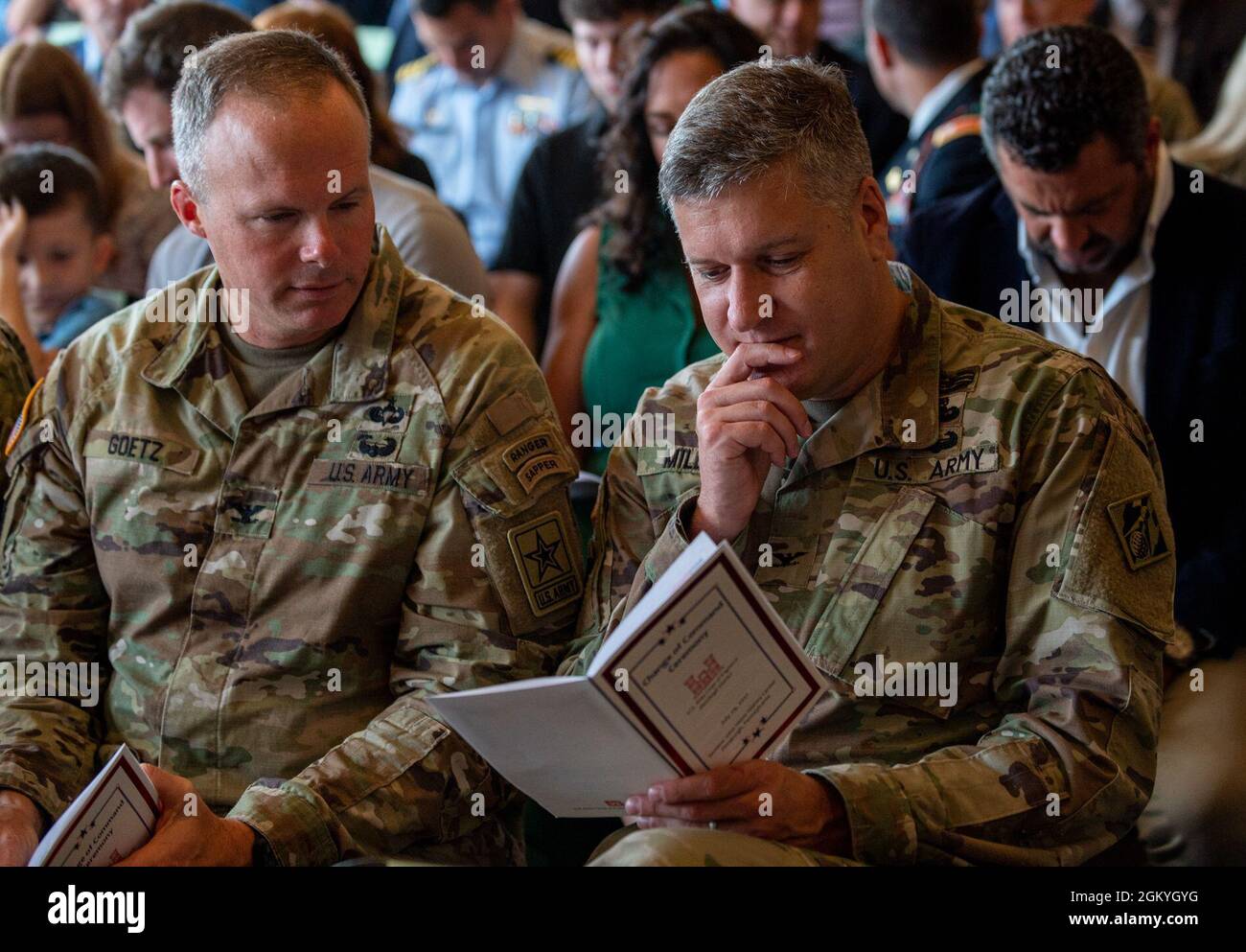 Guests look over the program prior to the Pittsburgh District change of command ceremony at the Senator John Heinz History Center, in Pittsburgh, July 29, 2021. The change of command ceremony symbolizes the continuation of leadership and unit identity. It represents the transfer of responsibility and authority from one individual to another while continuing the mission. Stock Photo