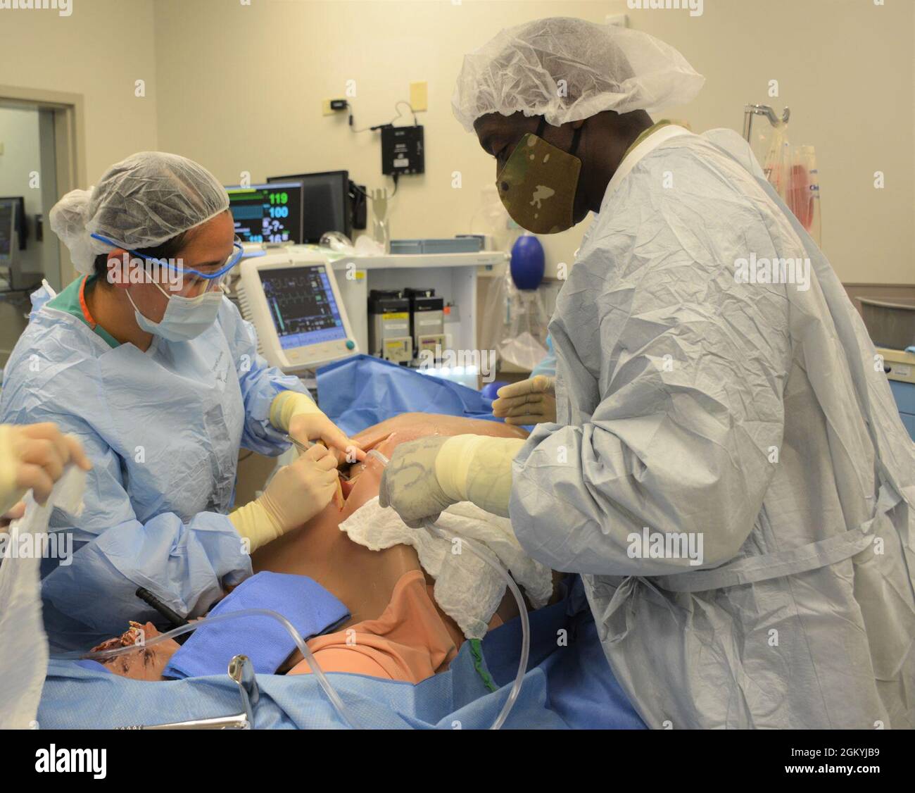Lt. Gen. Scott Dingle assists General Surgery Chief Resident Maj. (Dr.) Kelli Tavares during a simulated emergent exploratory laparotomy.    Tripler Medical Simulation Center holds three major accreditations which includes the Society of Simulation in Healthcare (SSH), top tier Comprehensive American College of Surgeons Accredited Educational Institute (ACS AEI) and the American Society of Anesthesia Maintenance of Certification in Anesthesia (MOCA). Having a top tier accredited simulation center allows TAMC to train the full spectrum of a ready medical force by providing direct support to res Stock Photo