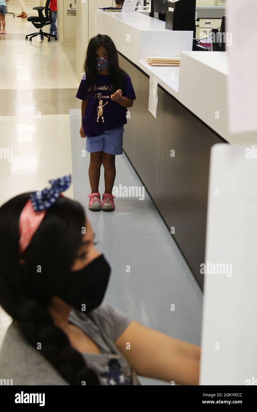 Olivia Garcia, 4, daughter of Jayme Mancera and Sgt. 1st Class Pablo Garcia, an observer, coach and trainer with Scorpion Team, Operations Group, identifies shapes July 29 during the vision station of back-to-school physicals at Weed Army Community Hospital, Fort Irwin, Calif. Stock Photo