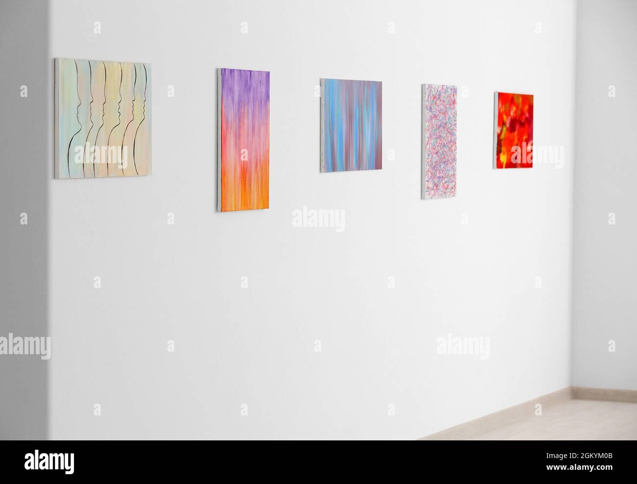 Beautiful paintings on white wall in art gallery Stock Photo - Alamy