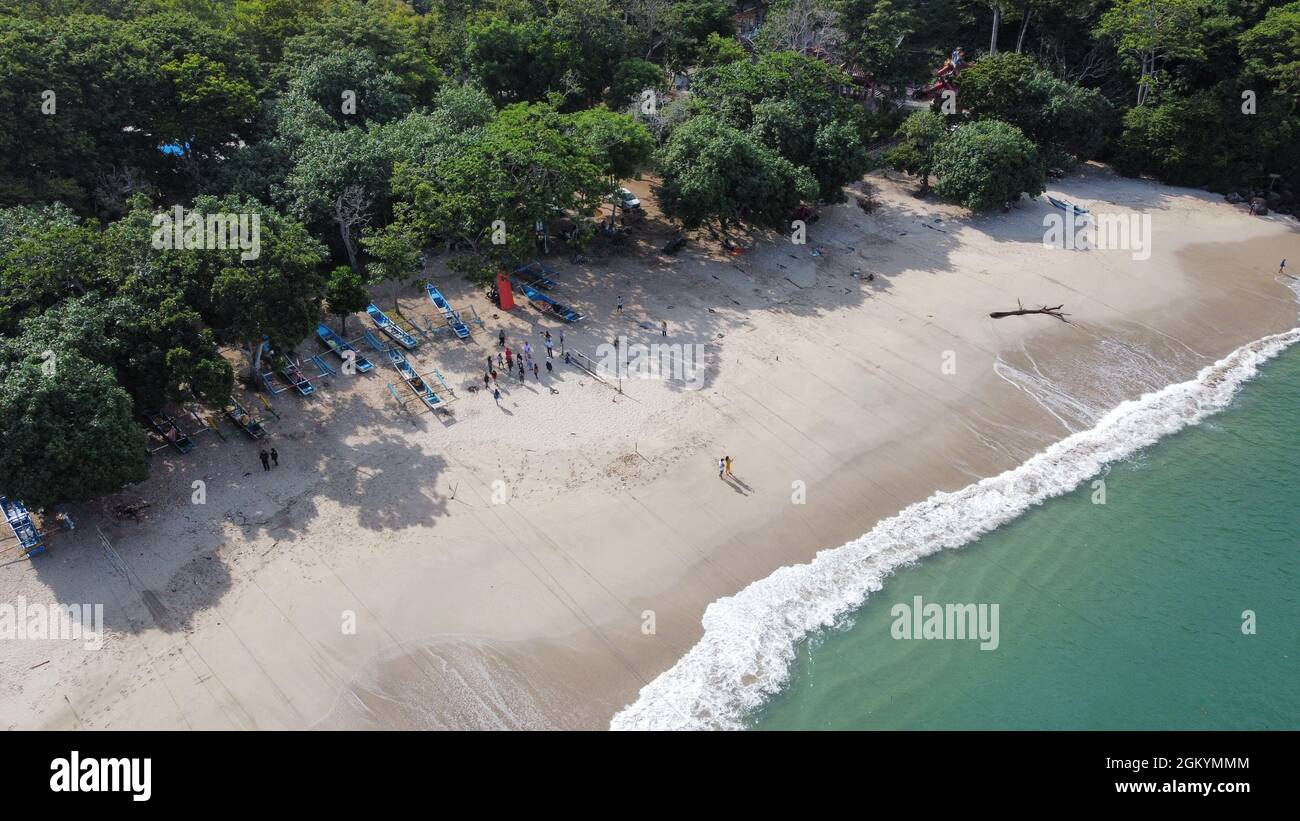 Aerial view of fishing boats and people at Tanjung Papuma Beach Stock Photo