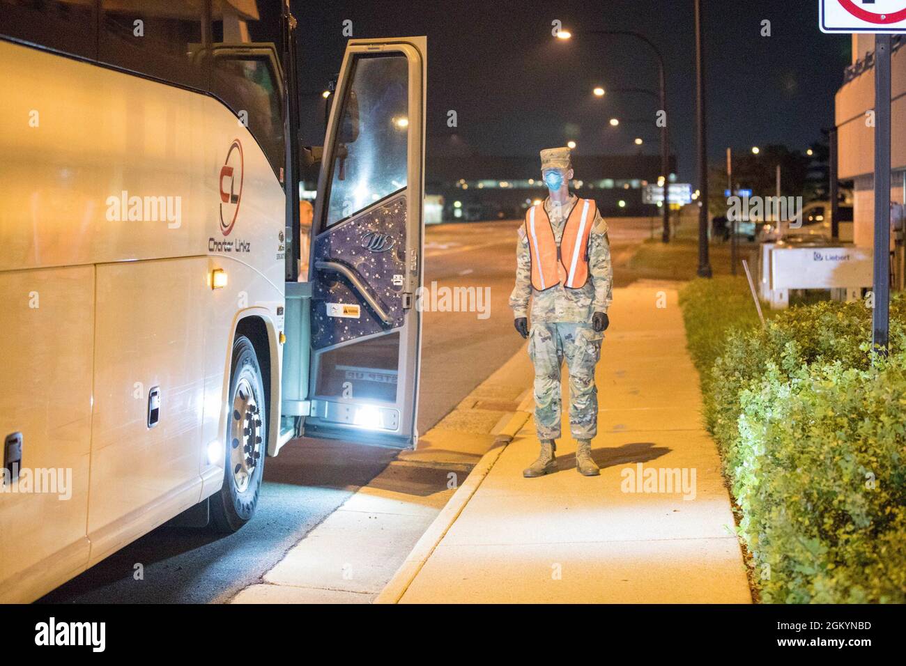 A U.S. Army Soldier assigned to 804th Transportation Detachment, 382nd Combat Sustainment Support Battalion, helps guide buses into position in support of Operation Allies Refuge, July 29, 2021 at the Dulles International Airport in Virginia. The Department of Defense, in support of the Department of State, is providing transportation and temporary housing for Afghan special immigrant applicants recently relocated to the United States to complete the final steps of the immigration process. This initiative follows through on America's commitment to Afghan citizens who have helped the United Sta Stock Photo