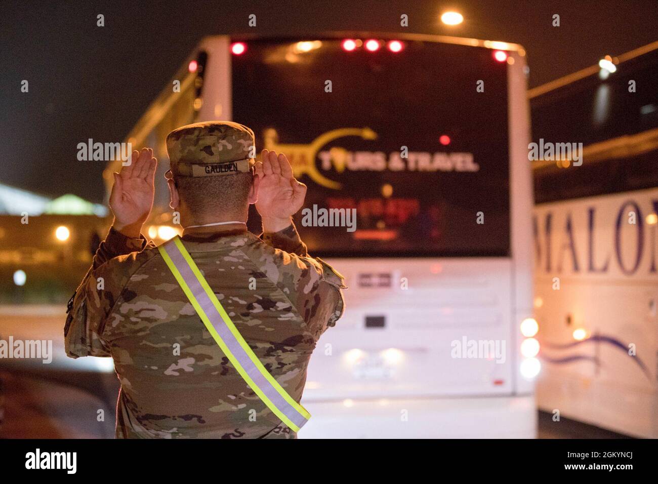 U.S. Army Pvt. Tyson Gaulden, assigned to 804th Transportation Detachment, 382nd Combat Sustainment Support Battalion, helps safely stage buses in support of Operation Allies Refuge, July 29, 2021 at the Dulles International Airport in Virginia. The Department of Defense, in support of the Department of State, is providing transportation and temporary housing for Afghan special immigrant applicants recently relocated to the United States to complete the final steps of the immigration process. This initiative follows through on America's commitment to Afghan citizens who have helped the United Stock Photo