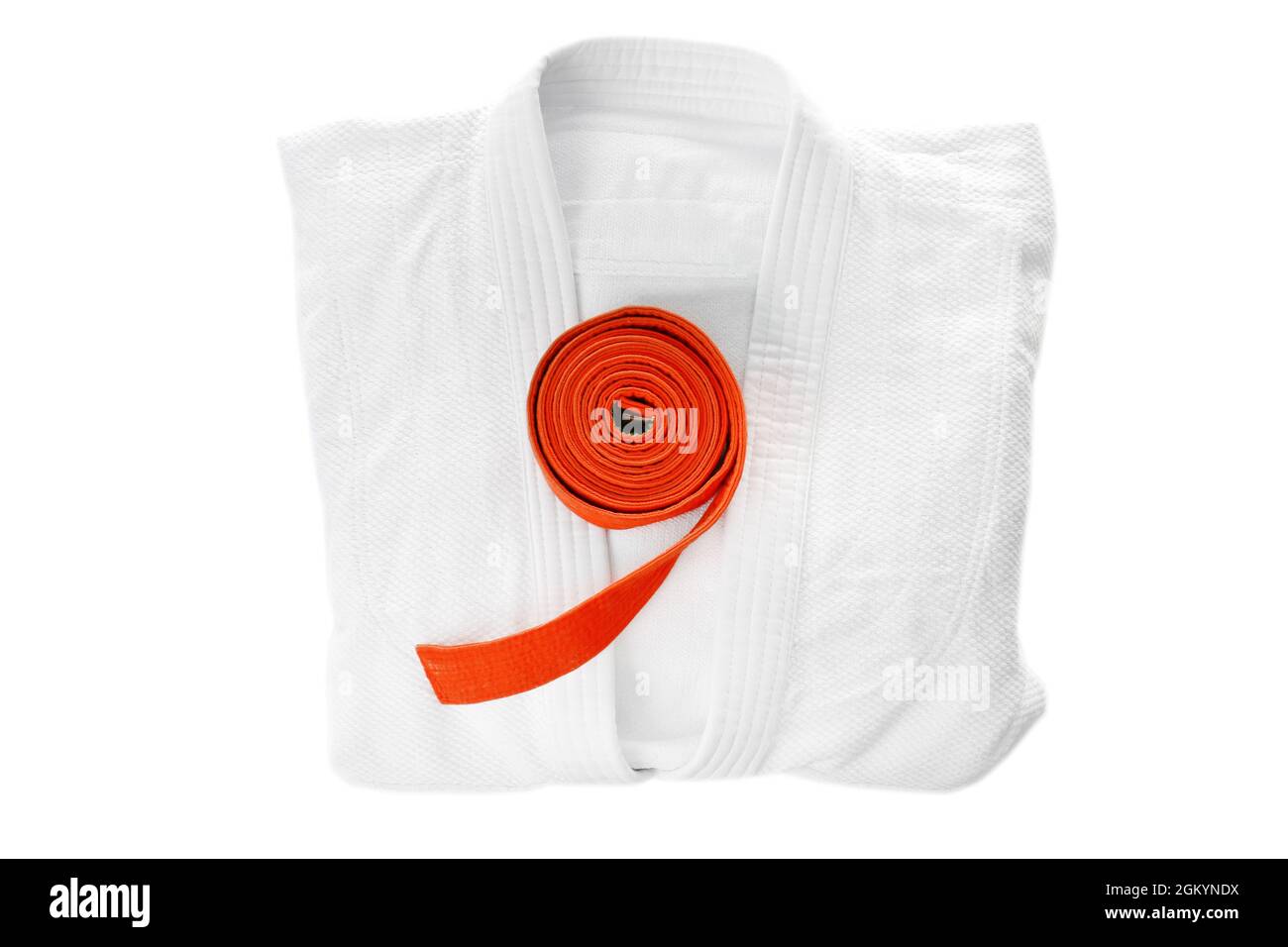 Karate uniform with orange belt on white background Stock Photo - Alamy