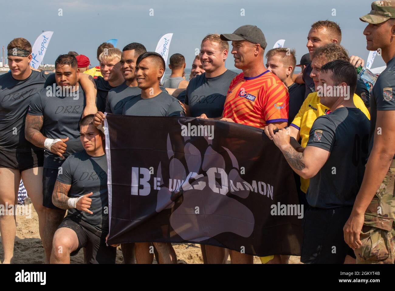 Soldiers from 3rd Battalion “Dark Rifles,” 161st Infantry Regiment present a unit flag to the president of Sopot, Poland, Jacek Karnowski, during the 9th Sopot International Beach Rugby Tournament in Sopot, Poland, July 31, 2021. The 3-161 is a Washington Army National Guard battalion on deployment as part of NATO’s Enhanced Forward Presence, Battle Group Poland to enhance interoperability. Stock Photo