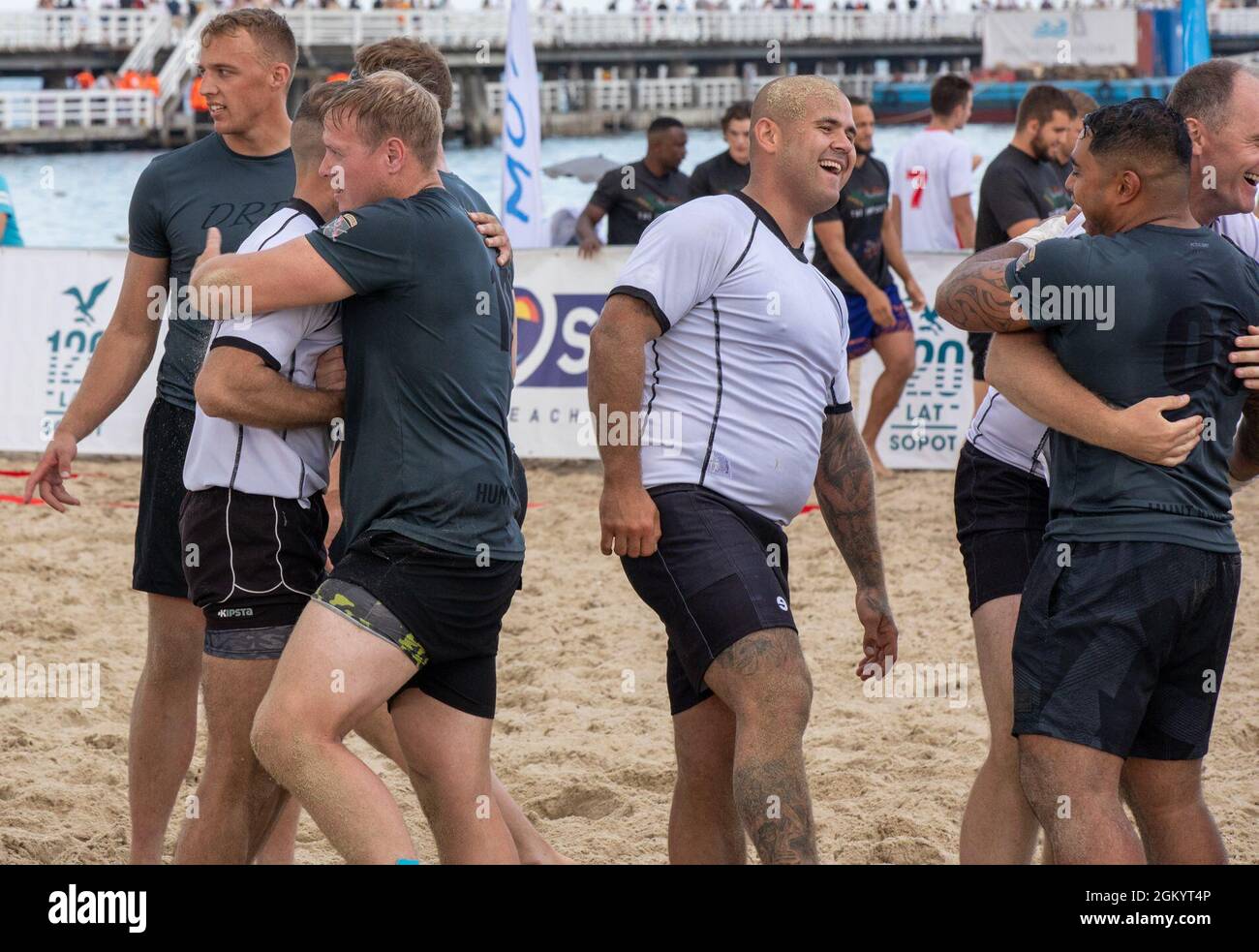 Soldiers with 3rd Battalion “Dark Rifles,” 161st Infantry Regiment shake hands and congratulate the opposing team after competing against each other at the Sopot International Beach Rugby Tournament in Sopot, Poland, July 31, 2021. The Soldiers competed in the tournament to strengthen bonds with Polish locals and support the Hodura Foundation, which is a foundation that organizes community events such as the rugby tournament. Stock Photo