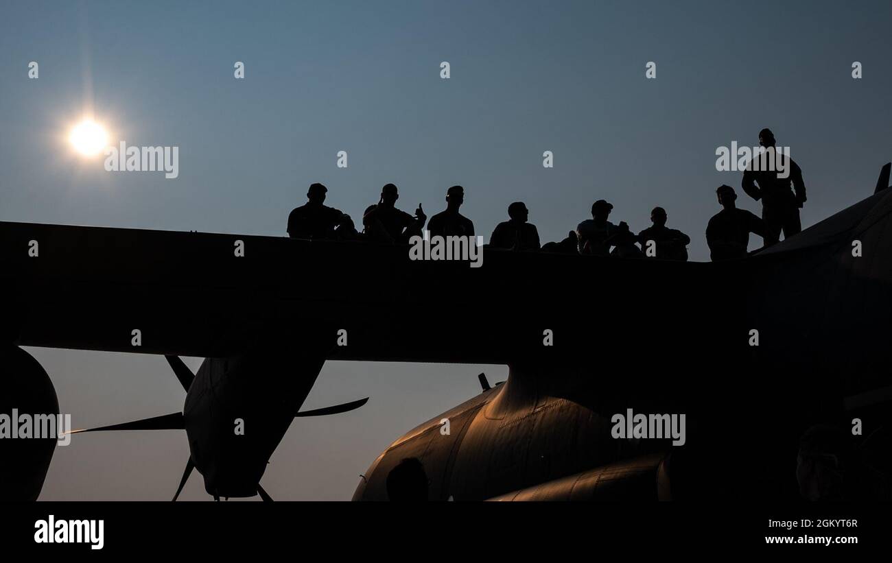 U.S. Airmen from the Air Force Special Operations Command watch an airshow from atop their AC-130J Ghostrider during EAA AirVenture Oshkosh 2021, at Wittman Regional Airport, Wis., July 31, 2021. AFSOC was featured at EAA’s airshow and brought multiple aircraft in its inventory to include the AC-130J Ghostrider, MC-130J Commando II, EC-130J Commando Solo, CV-22 Osprey, C-145 Combat Coyote, U-28 Draco, C-146 Wolfhound, MC-12 Liberty,  and the MQ-9 Reaper displaying capabilities of airpower through aerial demonstrations and/or static displays. Stock Photo