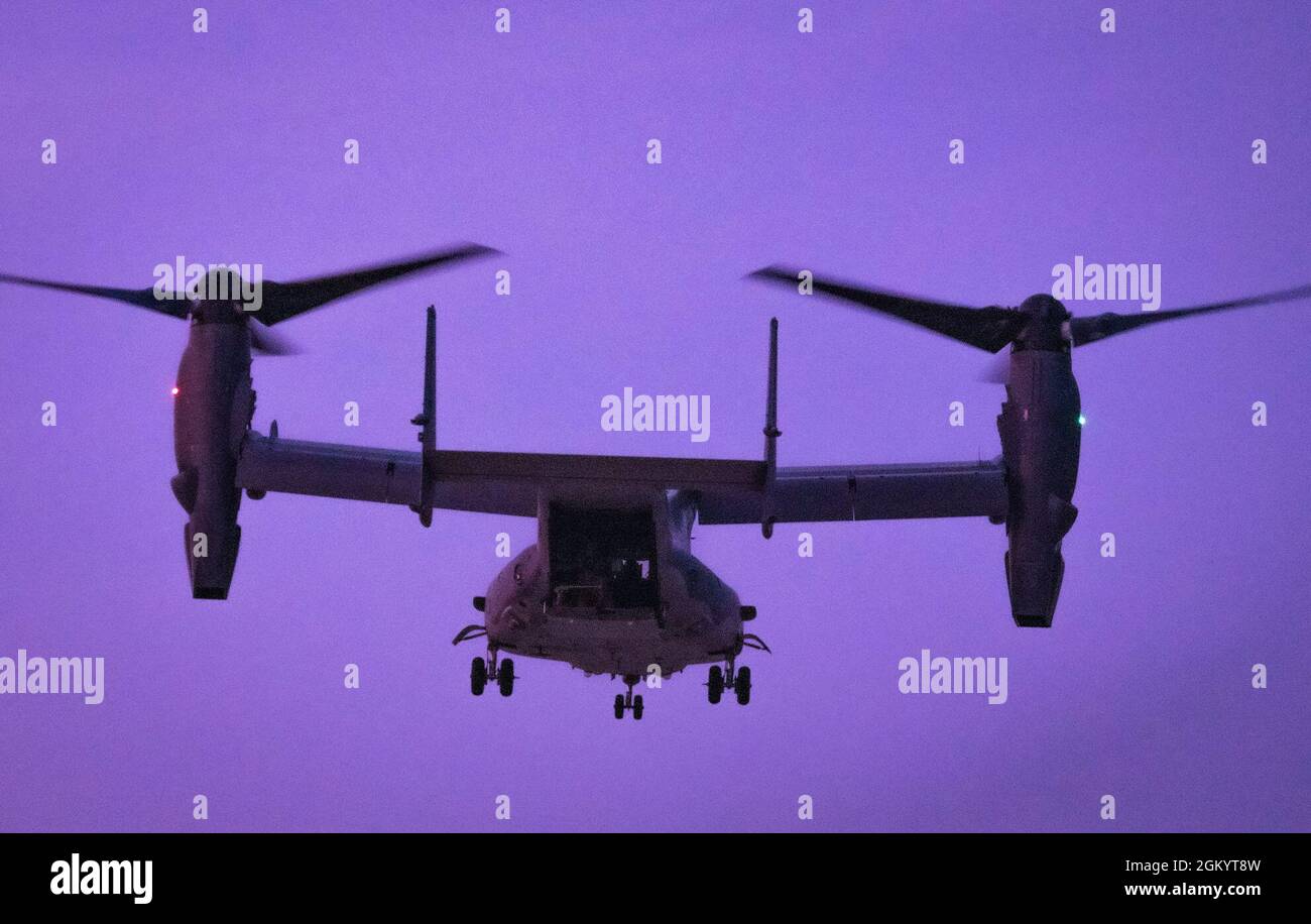 A CV-22 Osprey performs in an evening airpower demonstration as part of EAA AirVenture Oshkosh 2021, at Wittman Regional Airport, Wis., July 31, 2021. Air Force Special Operations Command was featured at EAA’s airshow and brought multiple aircraft in its inventory to include the AC-130J Ghostrider, MC-130J Commando II, EC-130J Commando Solo, CV-22 Osprey, C-145 Combat Coyote, U-28 Draco, C-146 Wolfhound, MC-12 Liberty,  and the MQ-9 Reaper displaying capabilities of airpower through aerial demonstrations and/or static displays. Stock Photo