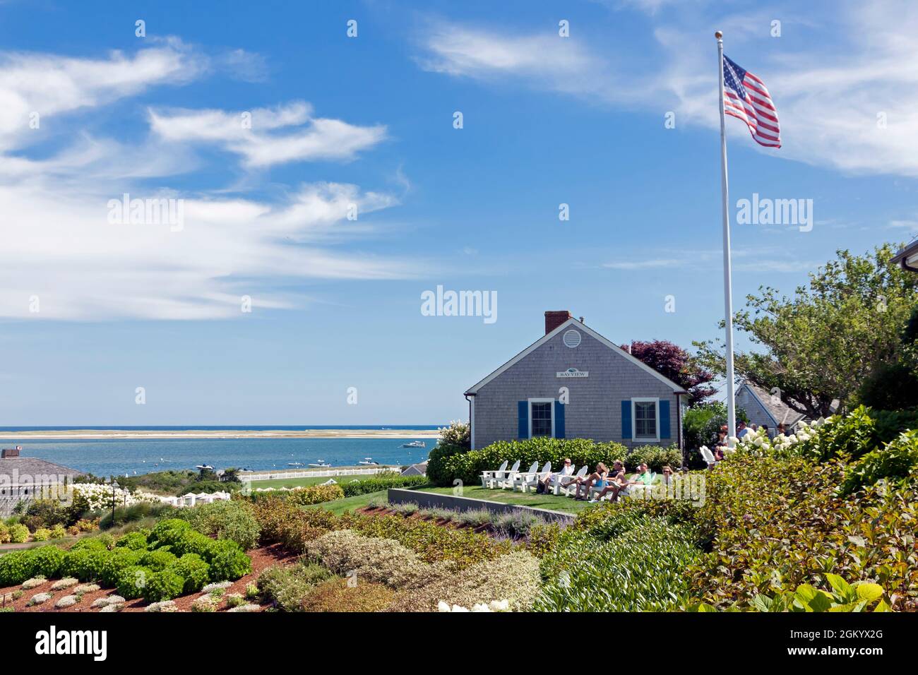 Visitors relaxing on lawn chairs overlooking ocean at Chatham Bars Inn, Chatham, Massachusetts (Cape Cod). Stock Photo