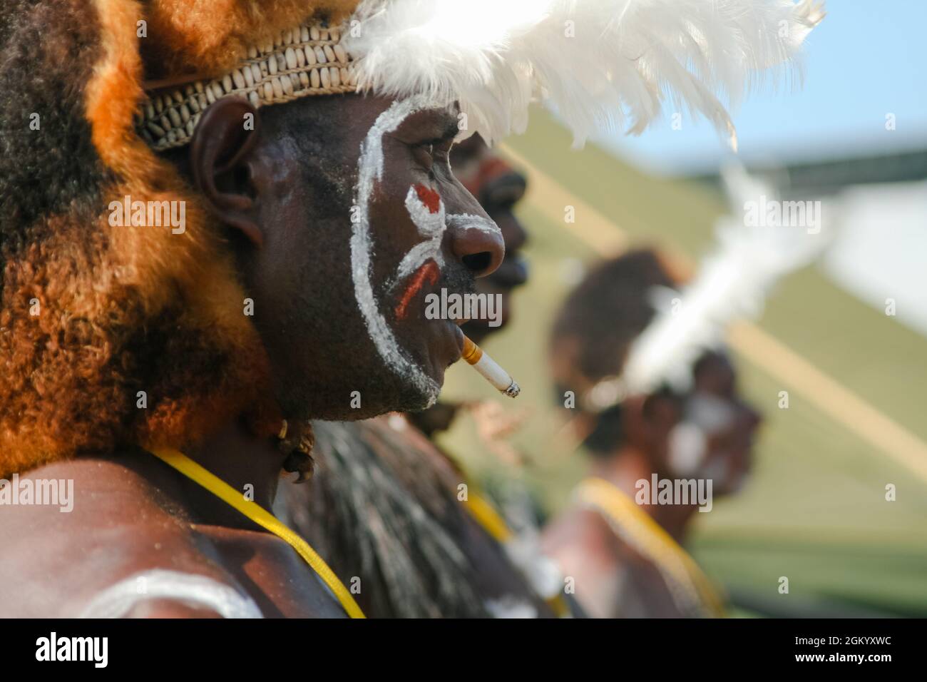 Asmat men attending the Asmat Festival in Ancol, Jakarta. One of them was smoking. Stock Photo