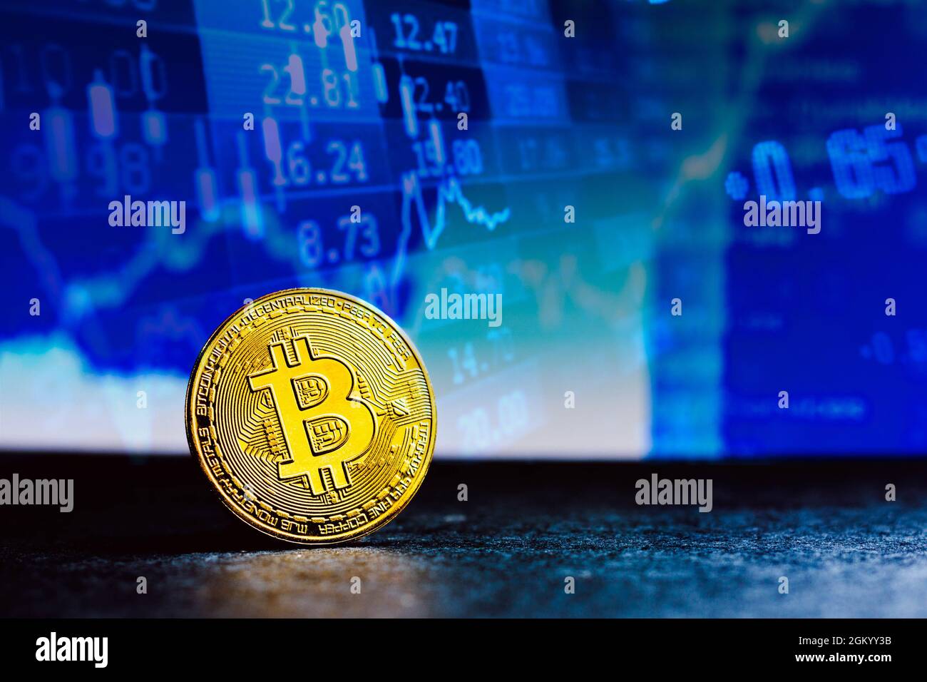 In this photo illustration, a gold Bitcoin seen on display with a stock ...